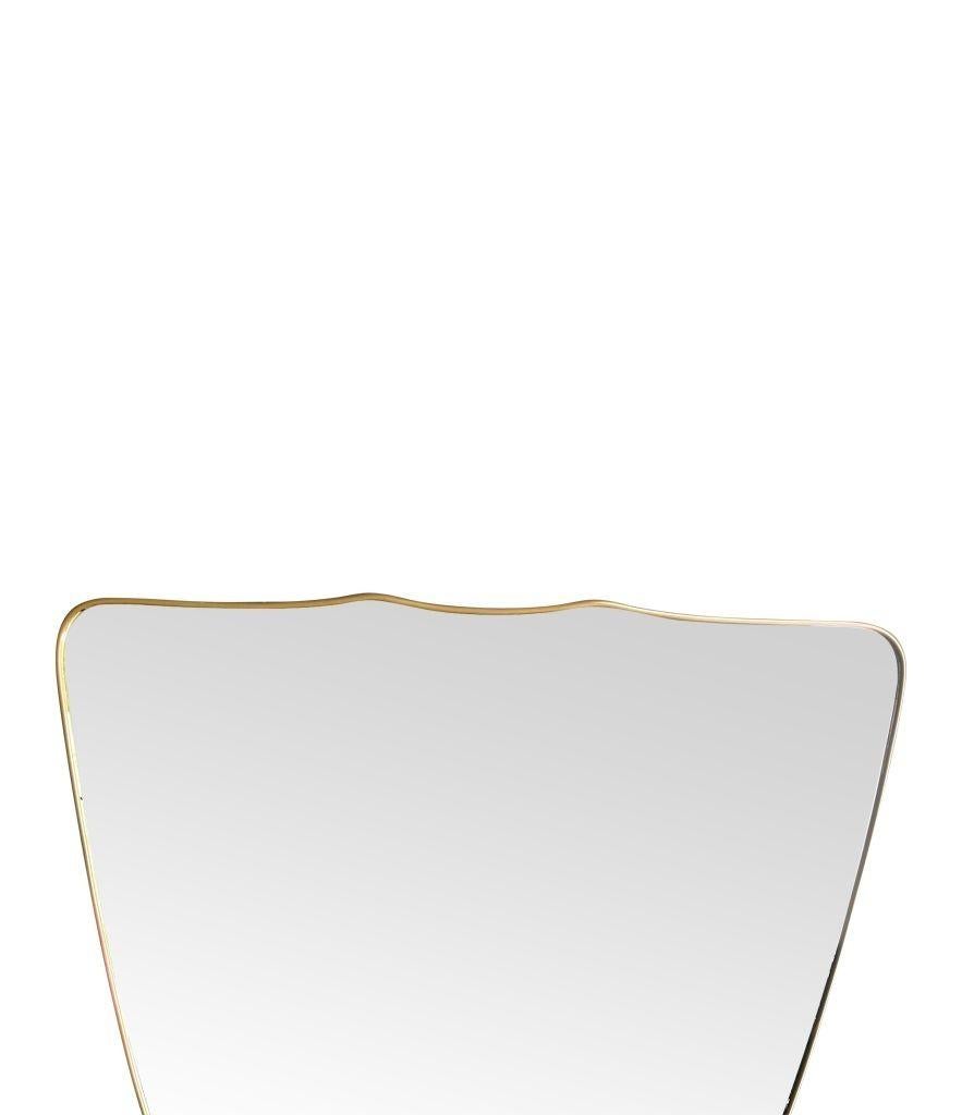 A large orignal Italian 1950s shield mirror with brass frame For Sale 1