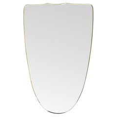 A large orignal Italian 1950s shield mirror with brass frame