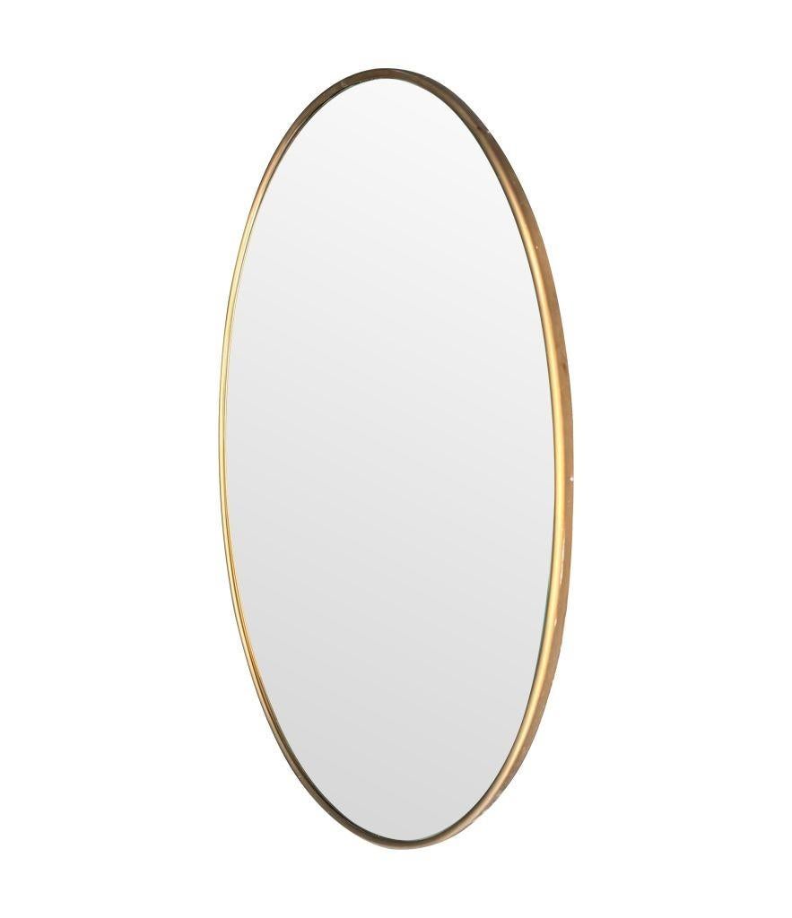 A large orignal Italian 1960s oval brass framed mirror For Sale 2