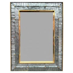A large orignal Italian 1970s solid brass mirror with blue Murano glass frame
