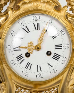 A Large Ormolu and Chased Cartel Clock in the Louis XV Style, 19th Century.