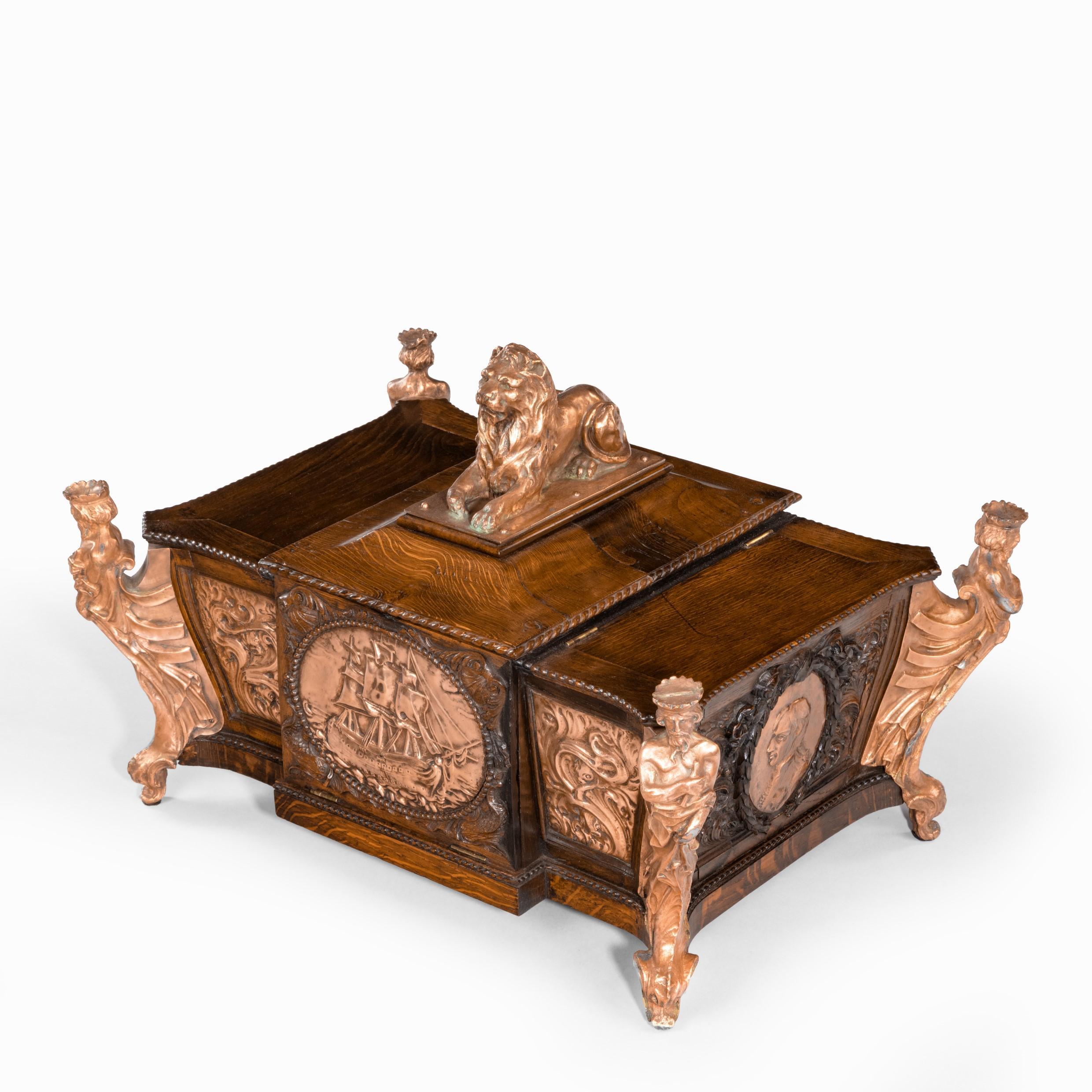 A large ornamental casket made from the oak and copper of HMS Foudroyant, Nelson’s flagship 1799-1801, of rectangular form with a central recumbent copper lion flanked by two compartments with hinged lids,  each corner with a copper figure of