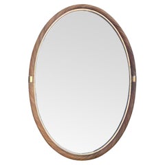 A large oval Italian 1970s Crespi style twisted rattan and brass mirror