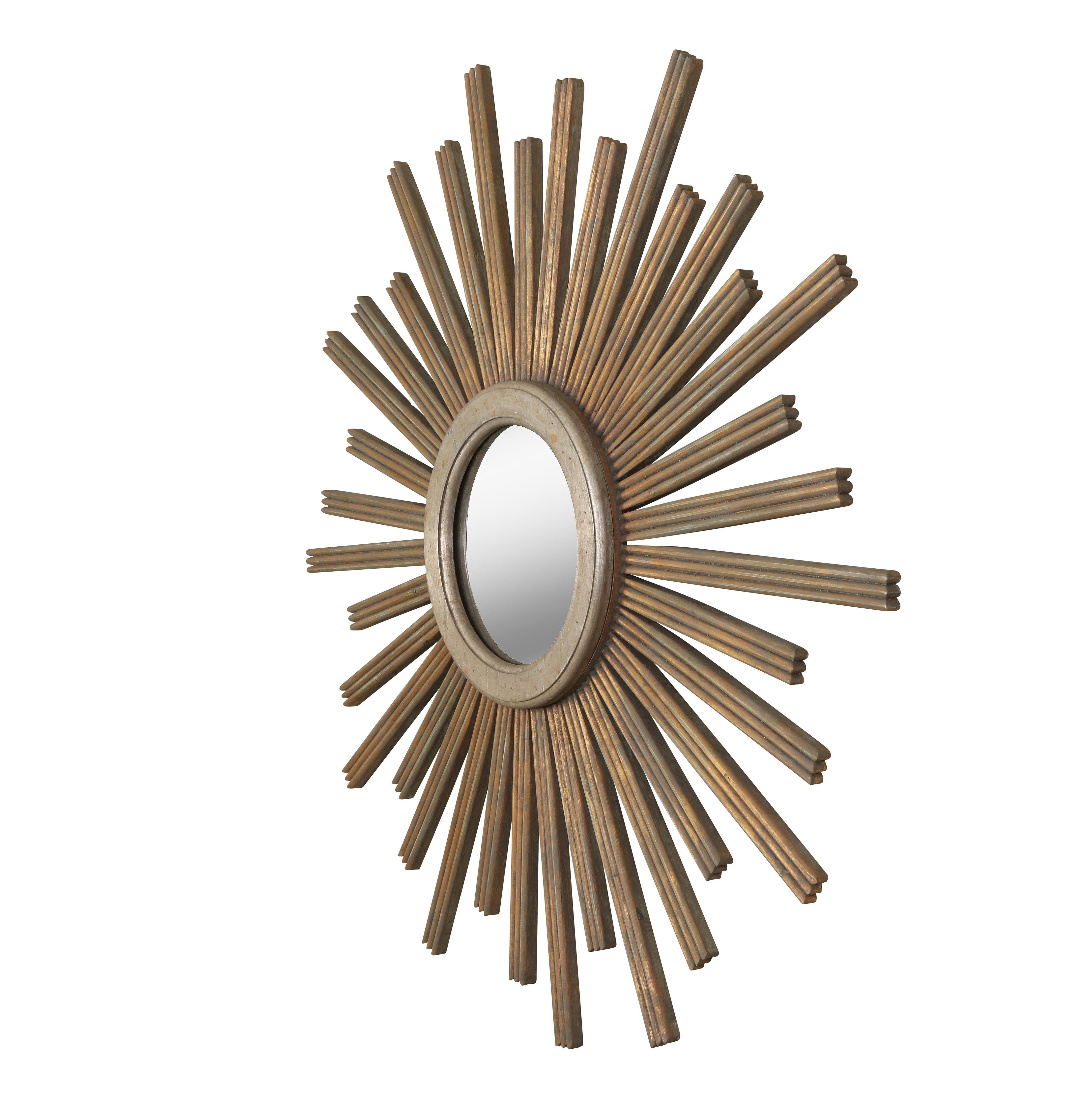 This large sunburst mirror will add a bit of drama and whimsy to any space.  Constructed of wood with a molded center ring,  he mirror has a painted/washed finish with subtle gold leaf accents.