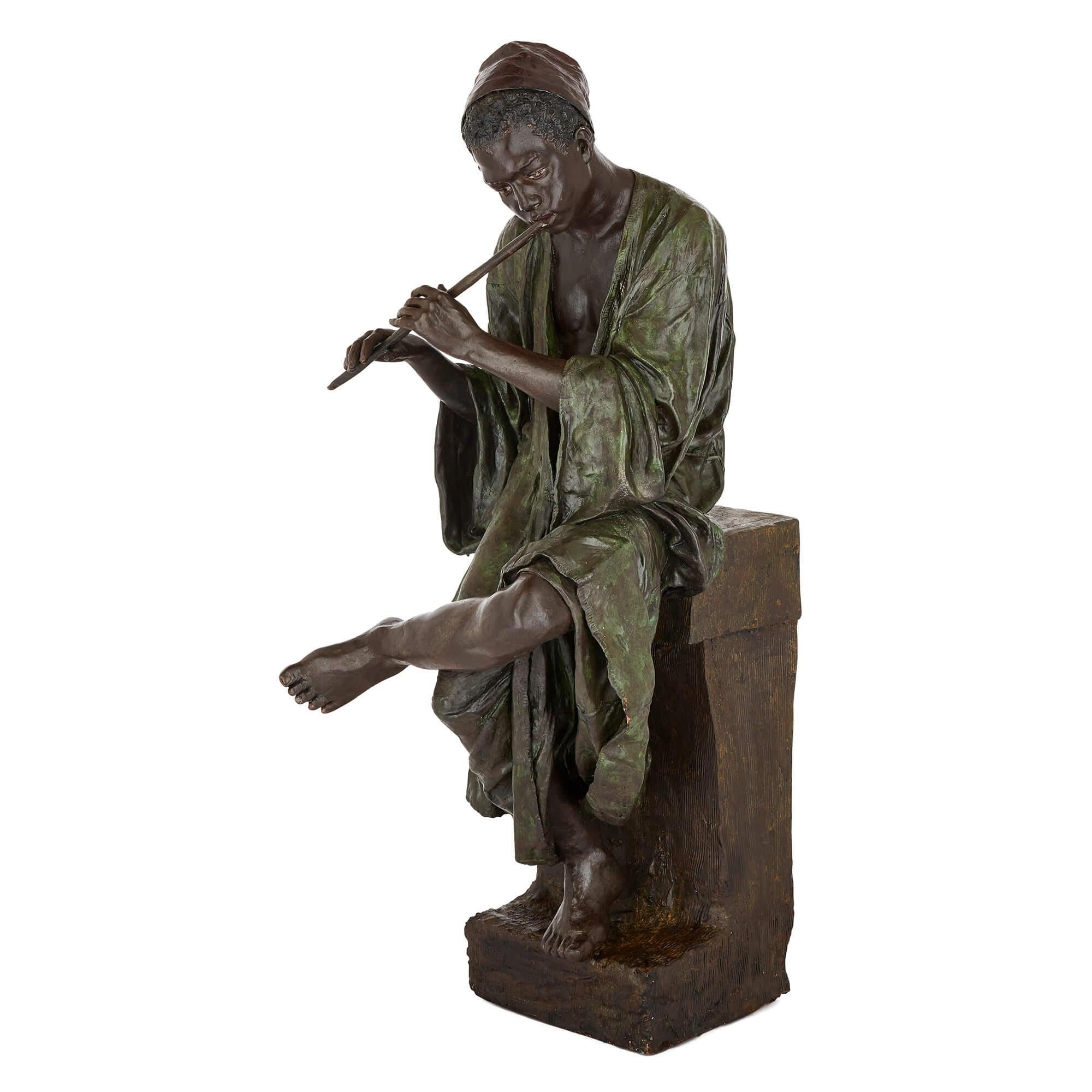 Autre Grande figurine en terre cuite peinte d'un garçon jouant de la flûte par Goldscheider en vente