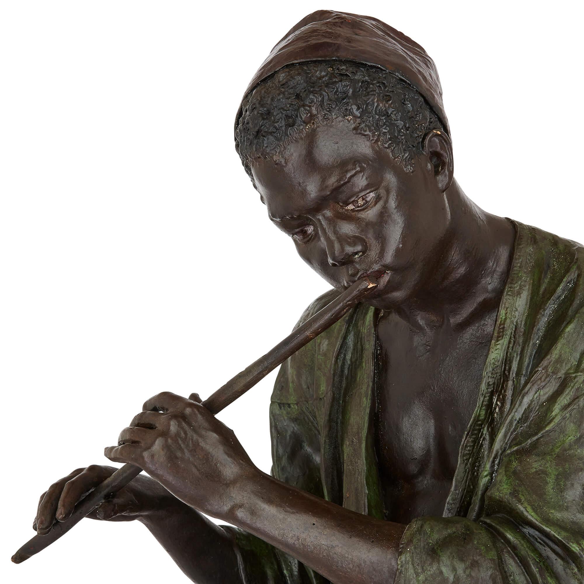 Peint Grande figurine en terre cuite peinte d'un garçon jouant de la flûte par Goldscheider en vente