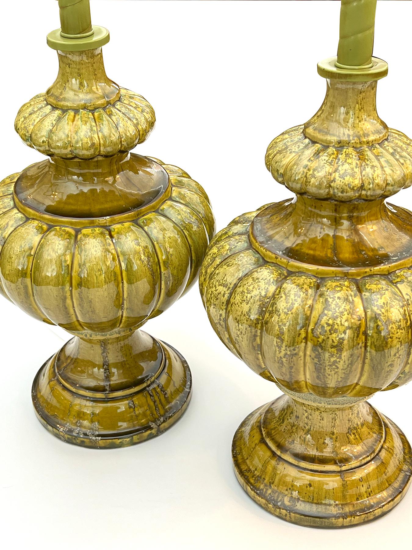 each richly-glazed lamp in a mottled chartreuse glaze with lobed collar above a short flaring neck over a lobed body resting on a splayed base