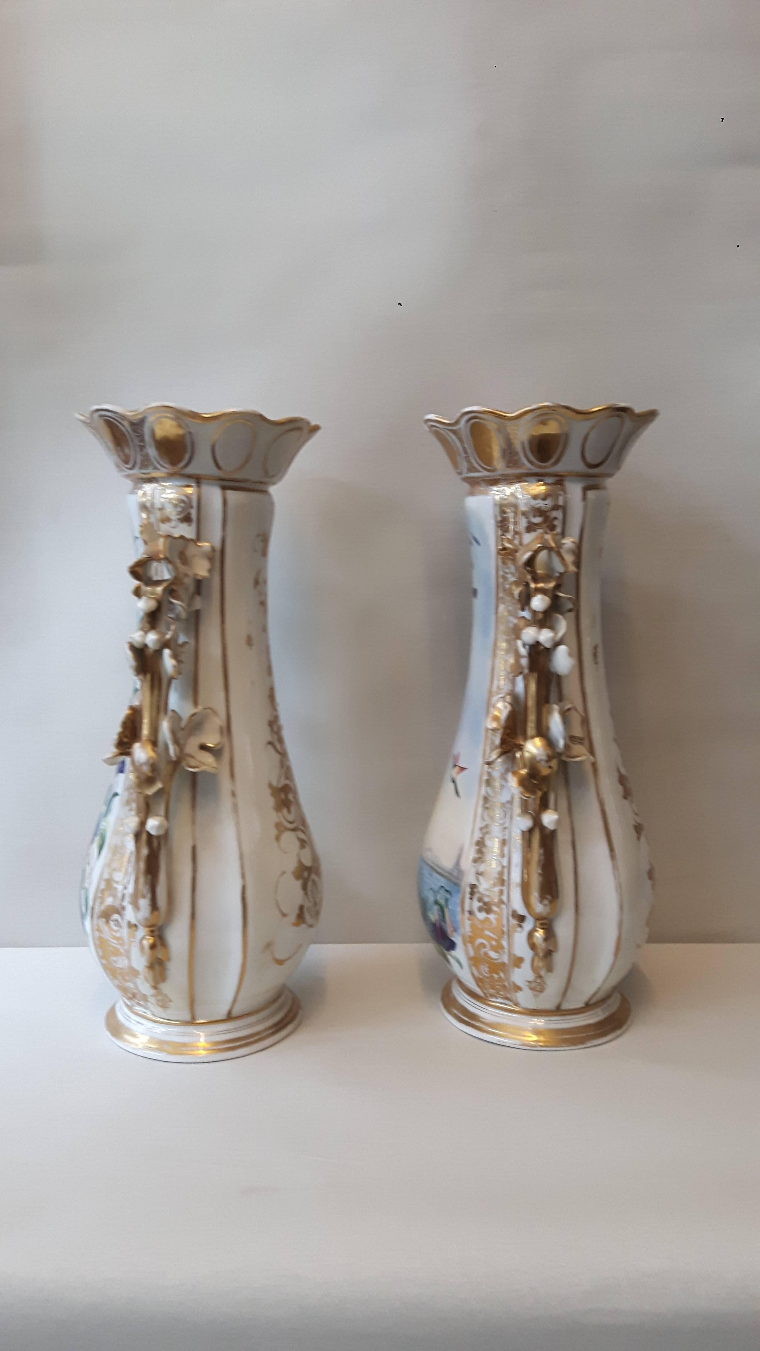 A charming pair of Paris porcelain vases with elegant flower moulded handles, the body hand-painted with lake views of Lac Léman, the cartouches framed by garlands of flowers.
French, circa 1880.