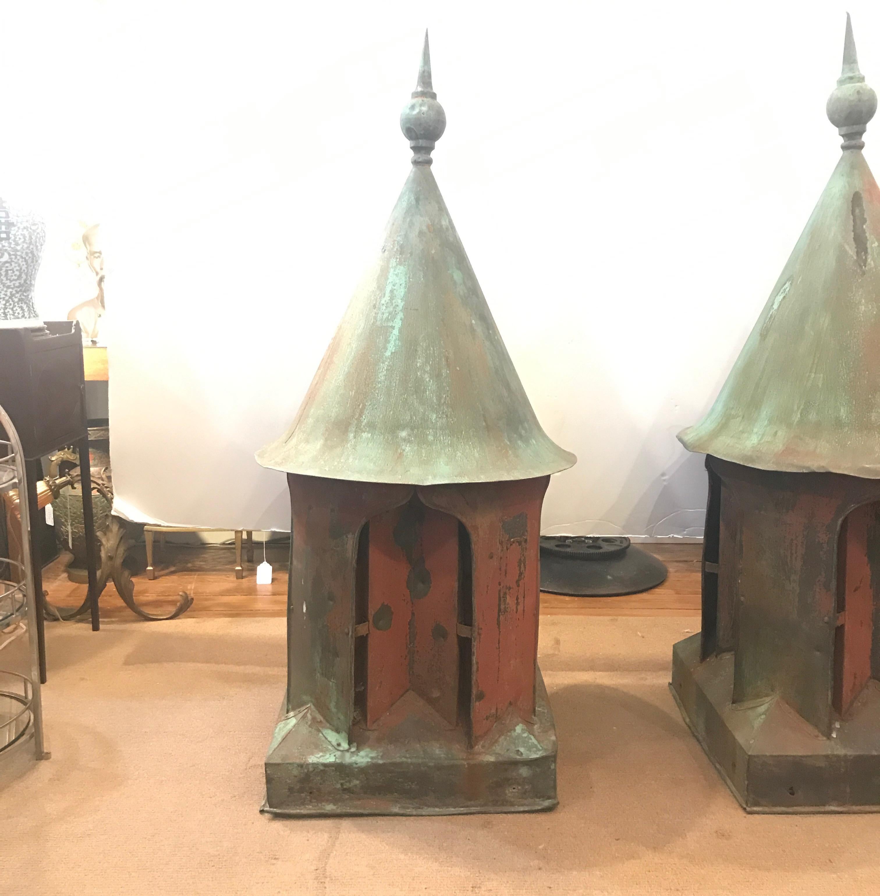 Impressive pair of antique English copper cupolas circa 1850s. The spire finial tops with round cone roofs over four sides with an arched opening. Each one with a label attached Ewart & Son Ltd, this company was responsible for the roof at