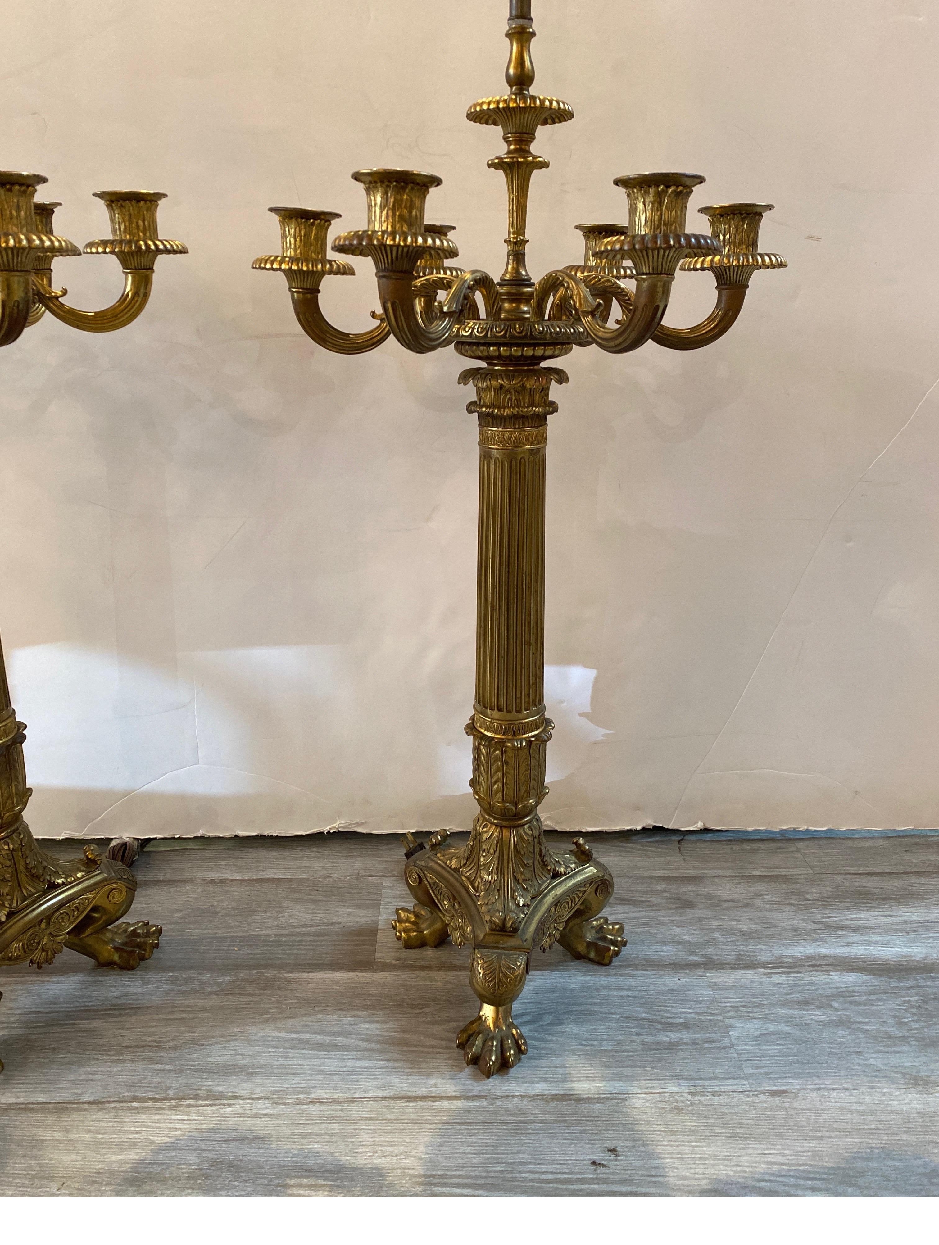 An impressive pair of cast bronze candelabra now as lamps. The Charles X style with six arms and center light with two sockets. The fine candelabra made around 1880, lamped in the 1920's. Fine casting with an aged gilt finish, These lamps are 42