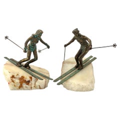A large pair of bronze cast skiers by Curtis Jere mounted on onyx slabs