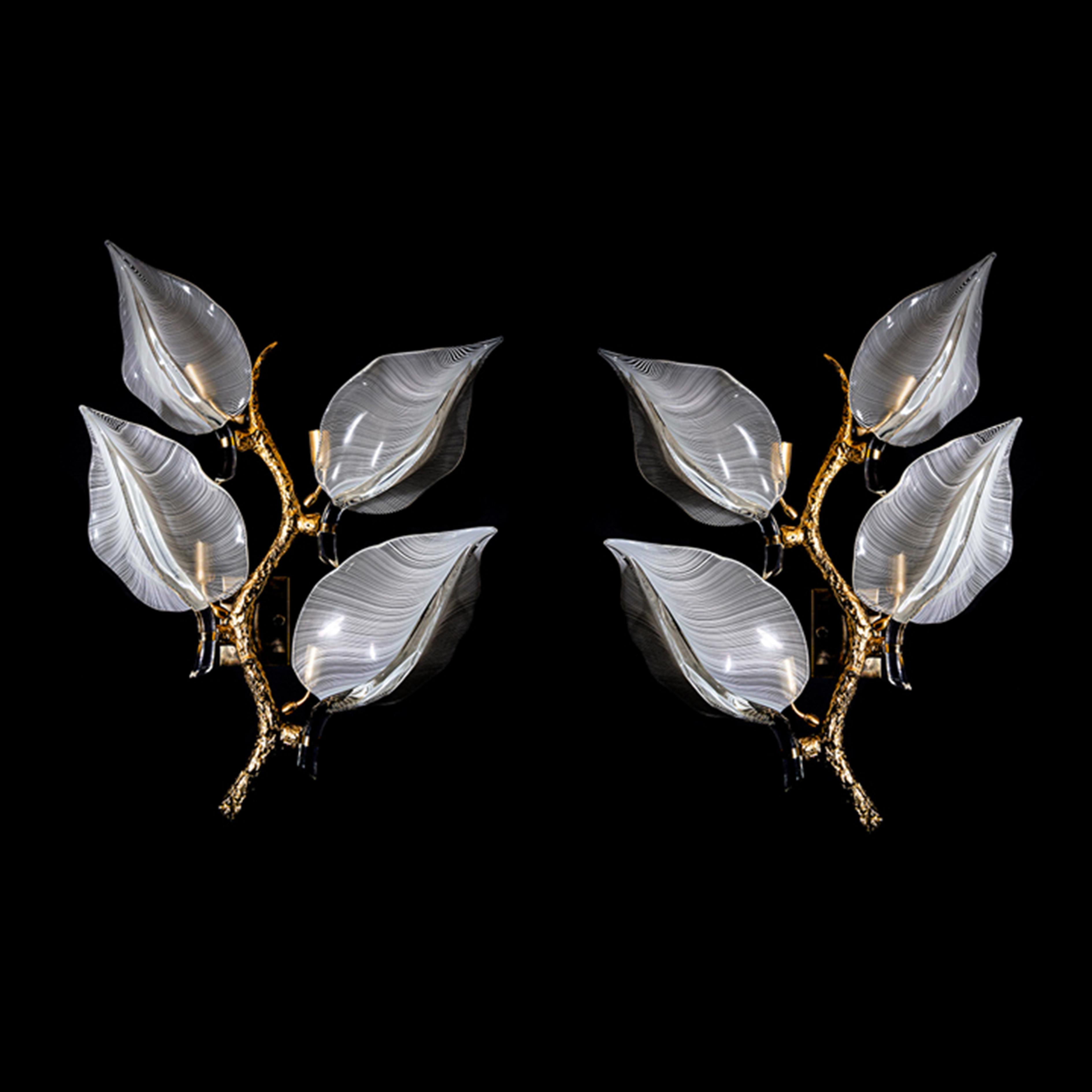 A large pair of bronze wall lights by Franco Luce. 
Featuring a stylized cast bronze branch stem with four
large murano glass leaves in a white filigrana technique
on each light.