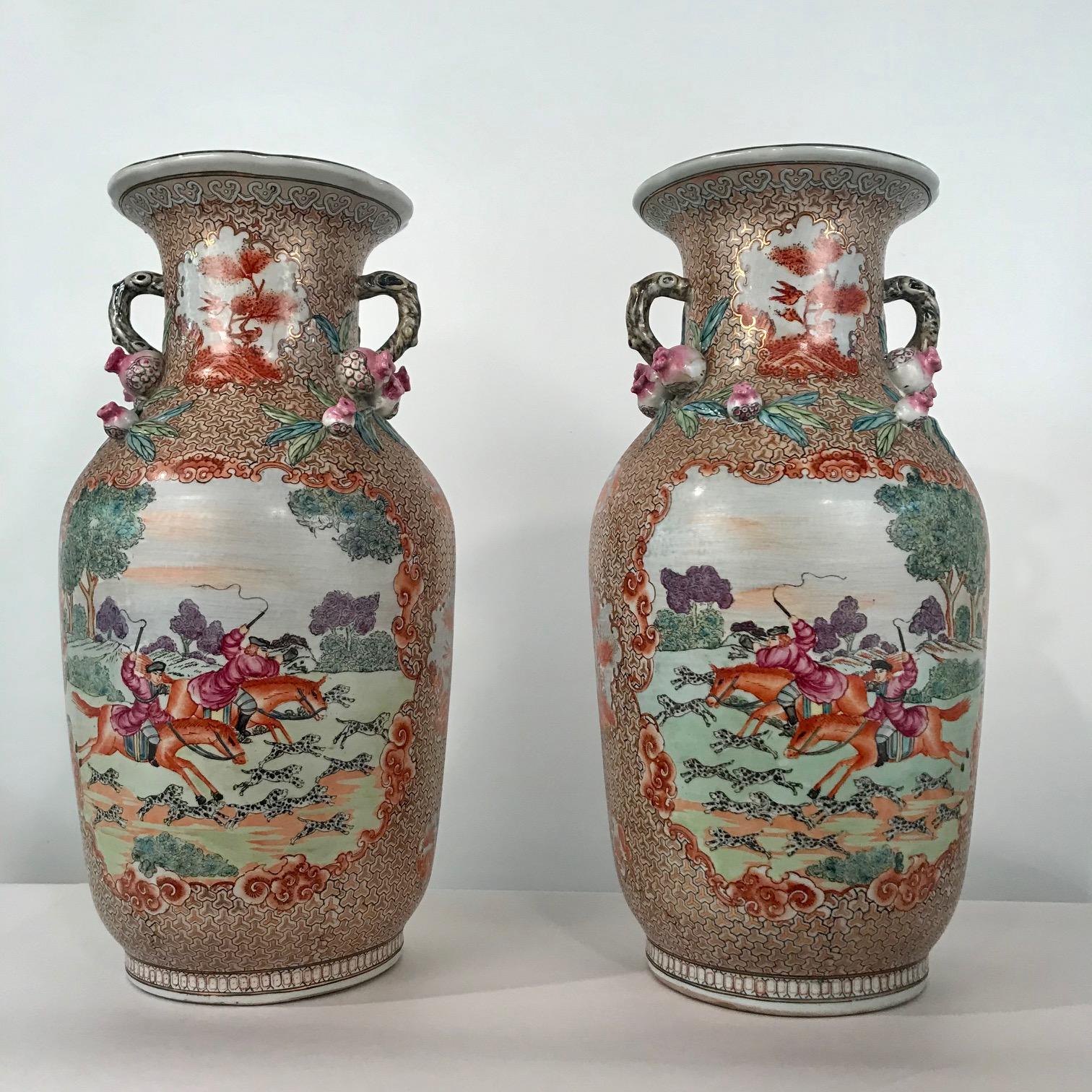 This pair of baluster vases, painted in the manner of the Export ware of the 18th century, combine a highly decorative gilt and painted ground with large and playful scenes in reserves…a French(?) gentleman and his son, hot on the chase. At their