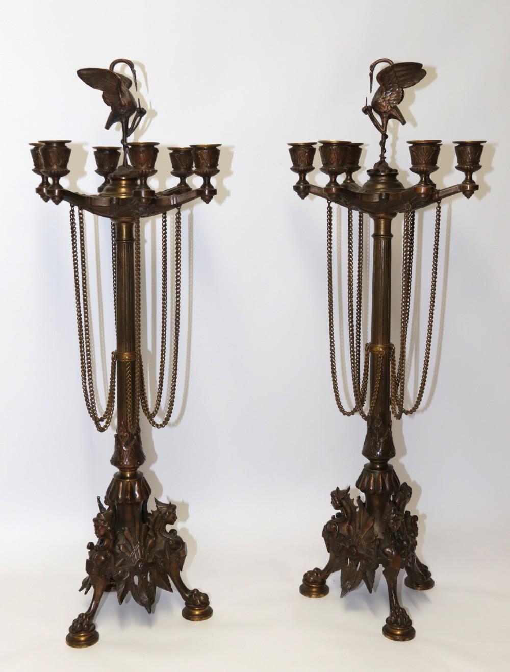 This large pair of cast bronze six branch candelabra were made in France circa 1860 in a Gothic style, cast with great detail and are in very good condition retaining their original bronze hanging chains which are often missing. This pair of