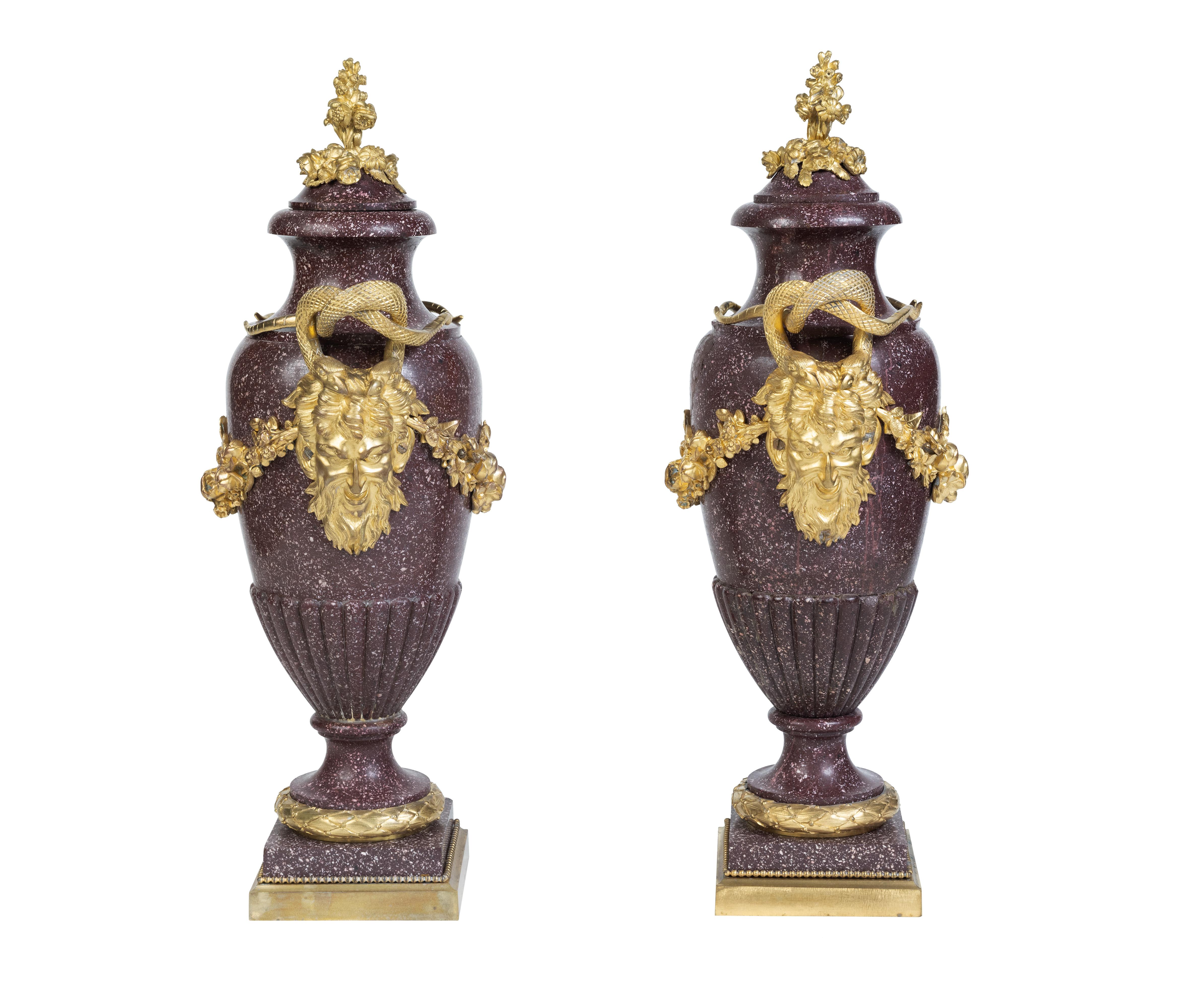 Elegance in Stone and Gilt: 

A Large Pair of French Ormolu-Mounted Egyptian Porphyry Vases, The gilt mounts 19th Century, the Porphyry, circa 1700's.

Embark on a journey through time with this exceptional pair of Large French Ormolu-Mounted
