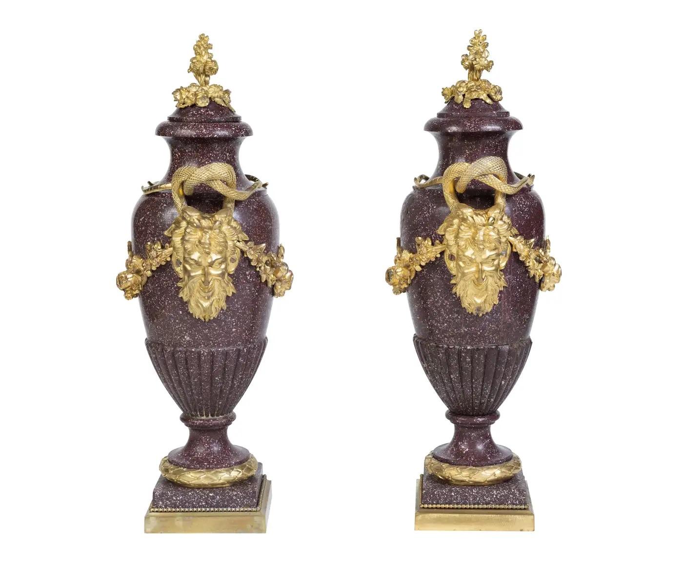 Elegance in Stone and Gilt:   

A Large Pair of French Ormolu-Mounted Egyptian Porphyry Vases, The gilt mounts 19th Century, the Porphyry, circa 1700's.  

Embark on a journey through time with this exceptional pair of Large French Ormolu-Mounted