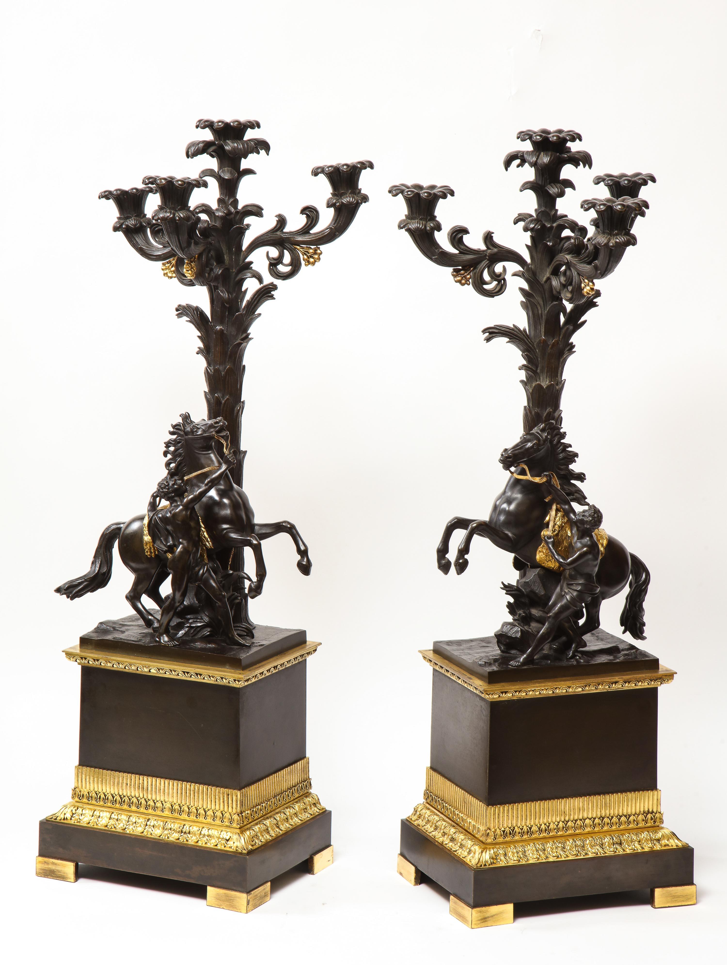 A large and fine pair of French restauration ormolu and patinated bronze four-light candelabra, with Marly Horses, after Guillaume Coustou, circa 1820.

Very fine, elegant and chic. This pair can be also turned into lamps.

Measures: 30