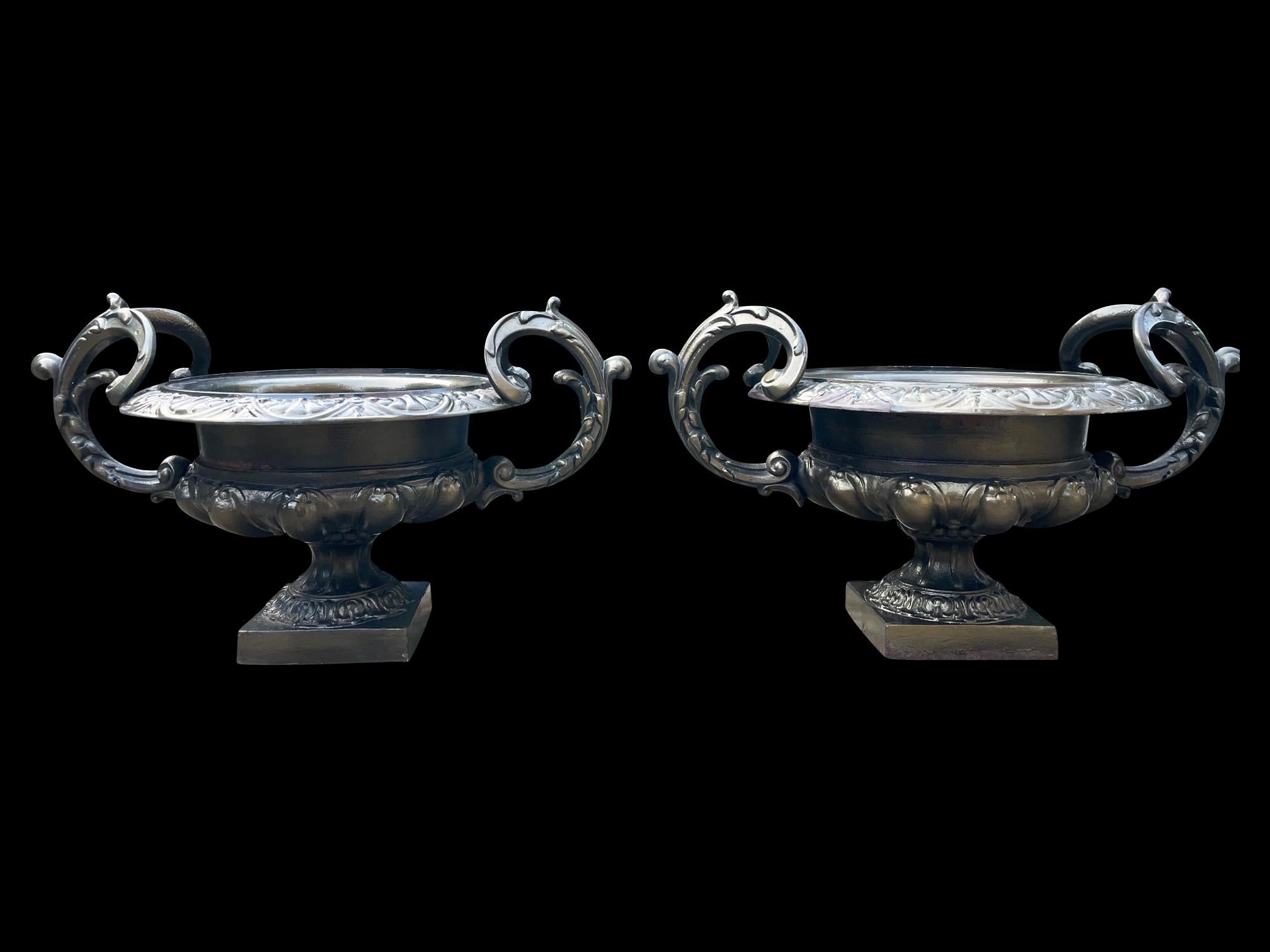 Cast A Large pair of French Urns with beautifully scrolled handles For Sale