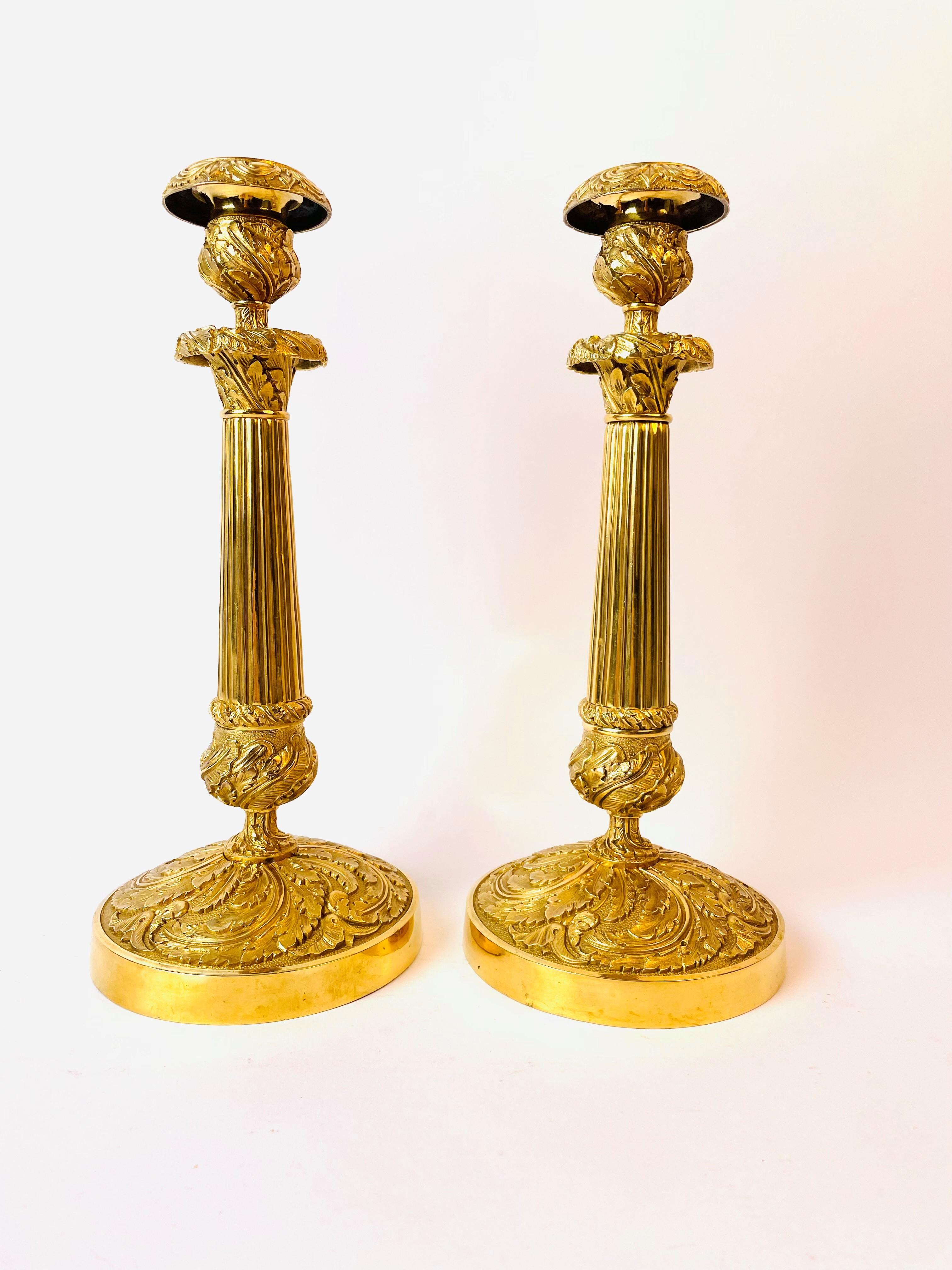 A large and excellent pair of gilt bronze candlesticks in French Empire, circa 1820. Very decorative with the twisted base and with a wonderful gilding.

Wear consistent with age and use.
   