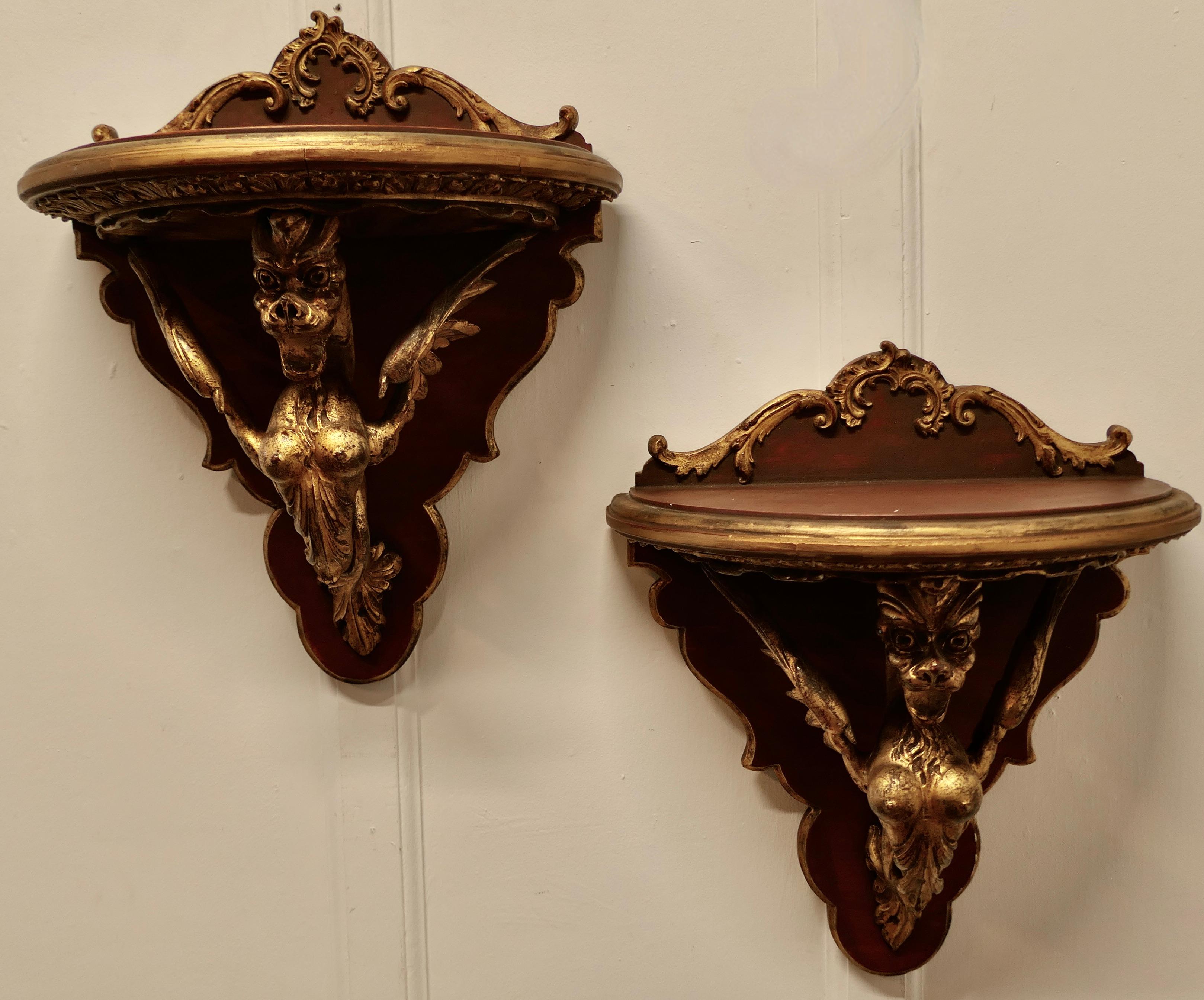 A Large Pair of Italian Carved Gilt Wall Brackets

These are a beautifully carved pair, Winged Griffins with breasts, piercing expression in their eyes and scroll feet supporting large Demi-lune wall brackets
There are superb pieces in good