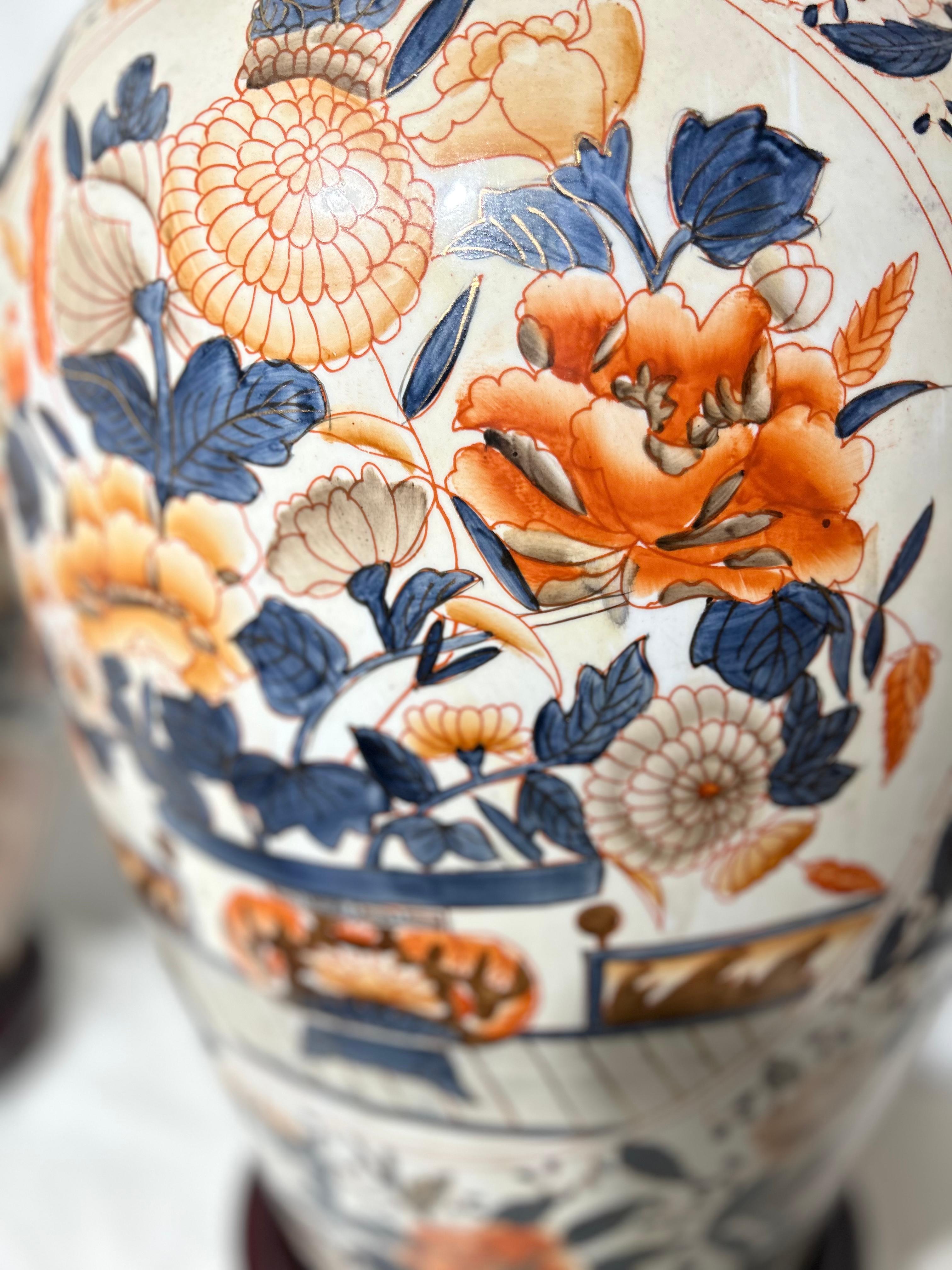 A fine pair of porcelain Japanese Amari lamps. Decorated with flowering branches, peacocks, birds, and fish in an array of vibrant colours.