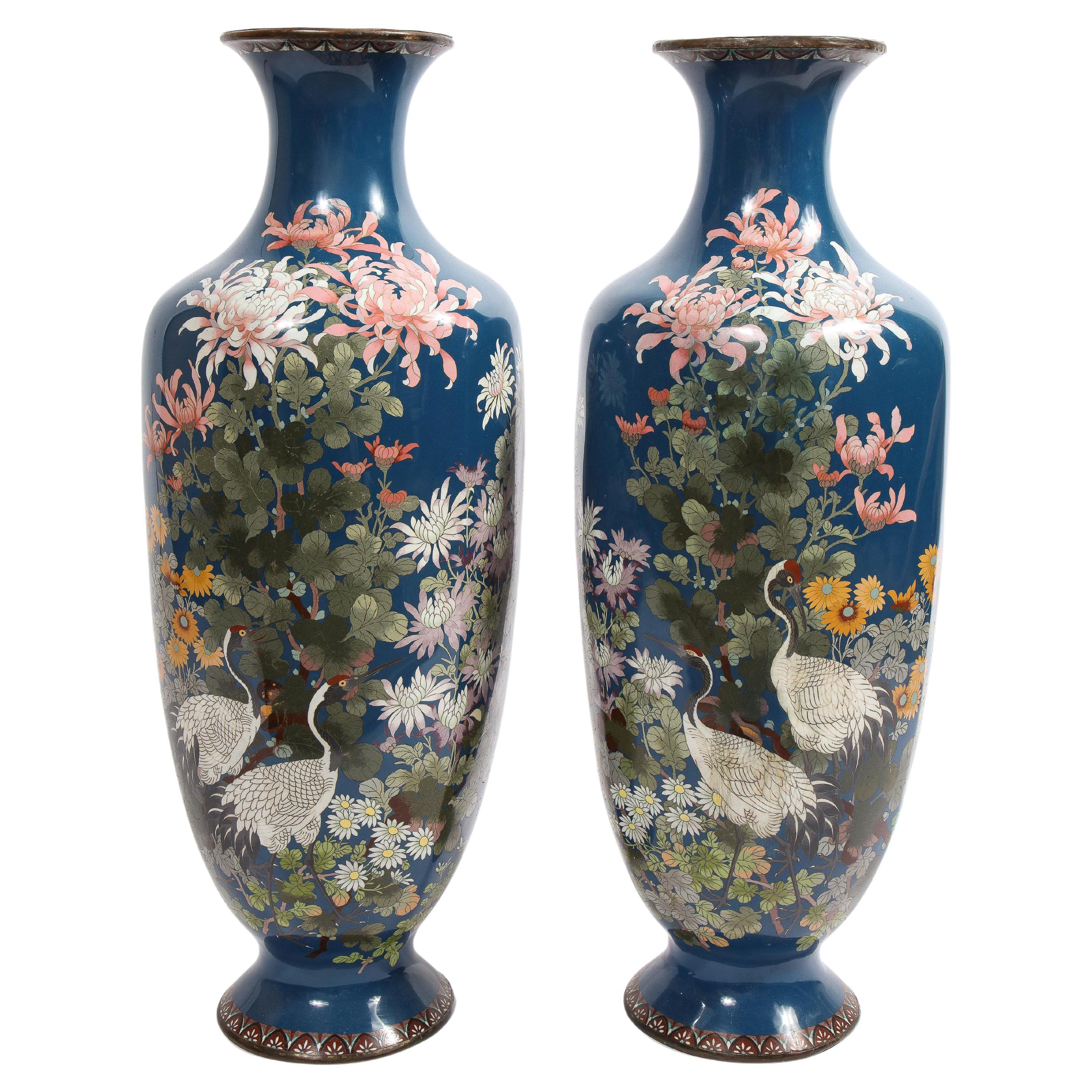A large pair of Japanese Meiji Period Blue-Ground Cloisonne enamel vases, 19th century.

Very nice quality, with cloisonne enamel throughout, depicting cranes, flowers and blossoms with a nice blue background.

Measures: 38