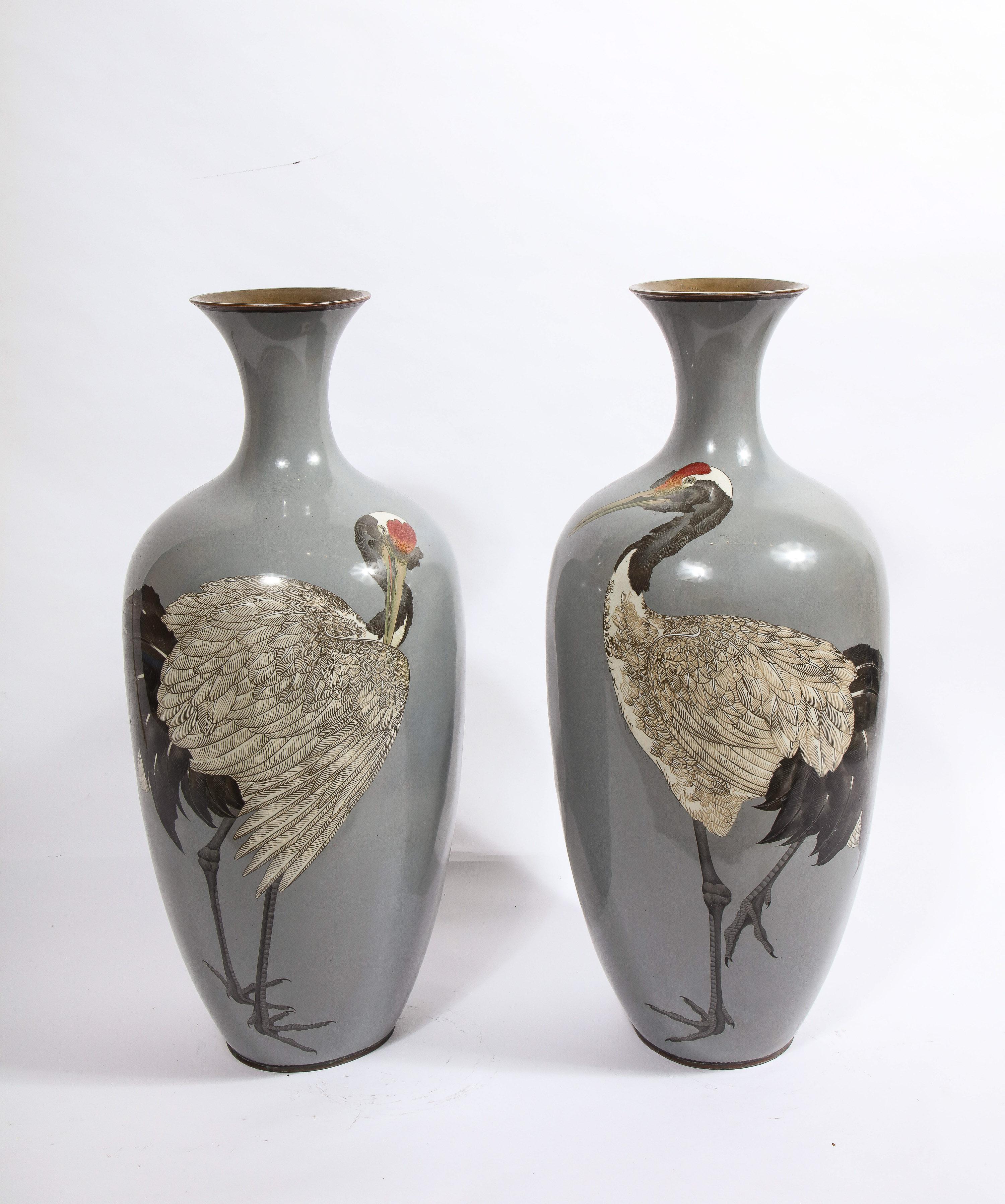 A Large Pair of Japanese Meiji Period Cloisonne Enamel vases with cranes.

Attributed to Hayashi Chuzo, this magnificent pair of vases are prime examples of Chuzo's workmanship. The quality of the enameled cranes, and the simplicity of form,
