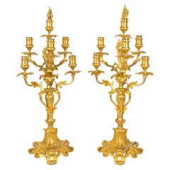 Une grande paire de candélabres de style Louis XV en bronze doré, signés Barbedienne.