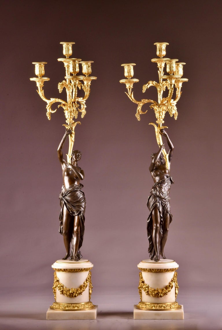 A pair of large Louis XVI gilt & patinated bronze Four-light candelabra, with scantly draped maidens. 
Diemensions: 88 x 25 x 25 cm.
 