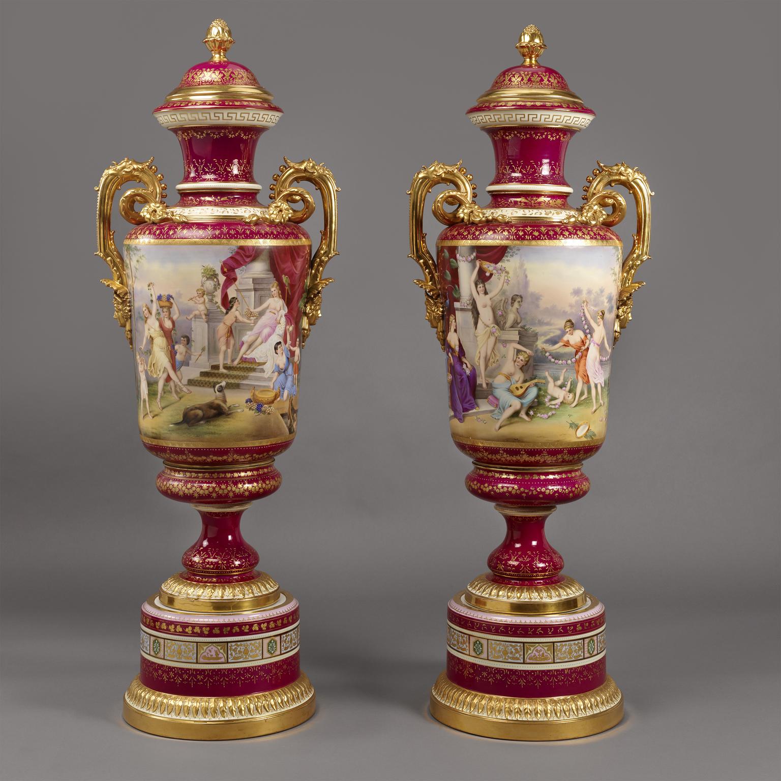 An important and extremely large pair of Magenta Ground Vienna Porcelain Exhibition vases. 

Austrian, circa 1900.

Each vase with blue underglazed ‘Beehive’ mark to interior of neck. 

Each vase is finely painted with classical scenes to the