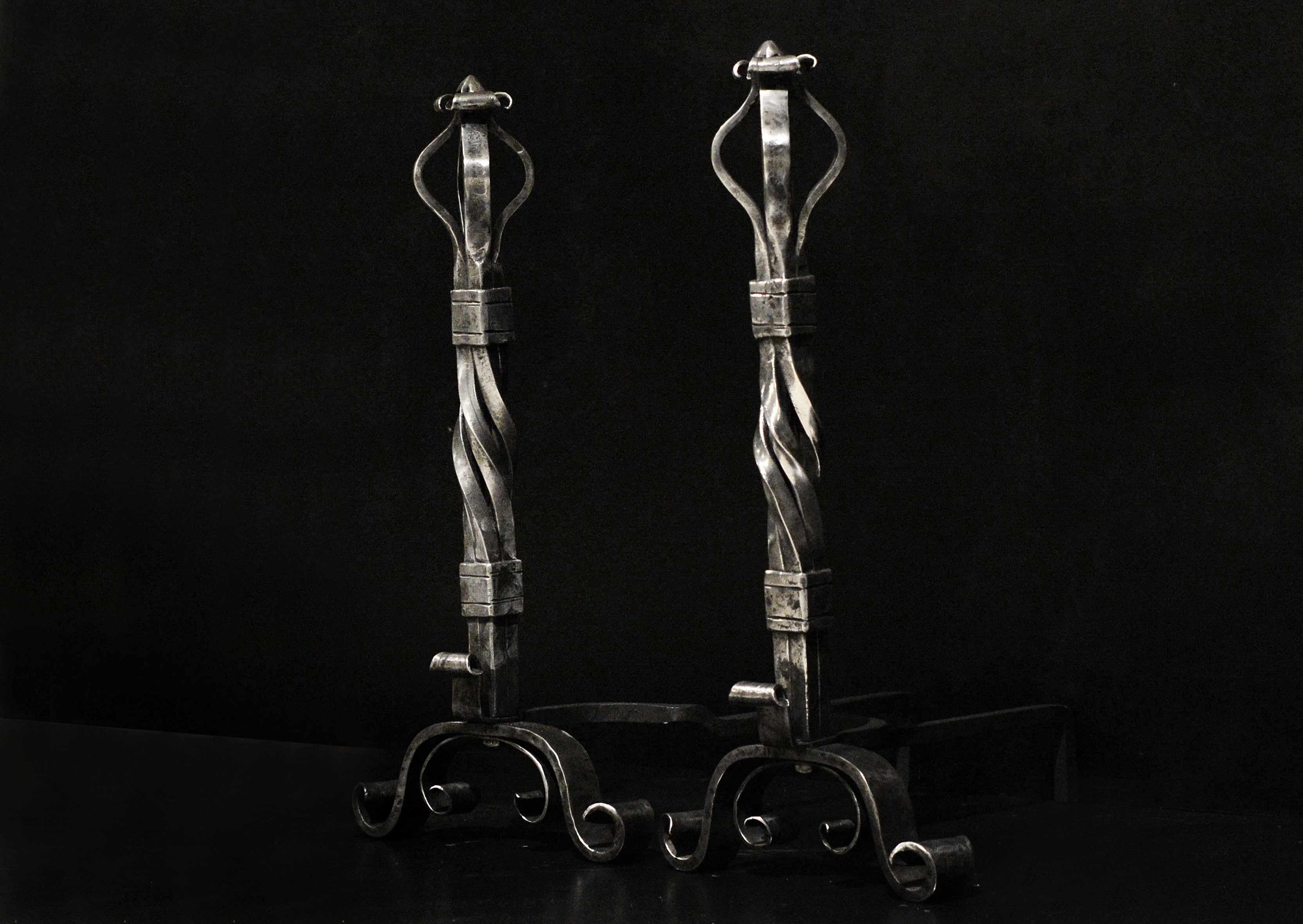 A fabulous pair of polished large wrought iron firedogs. The scrolled feet surmounted by barley twist shafts and shaped tops. An impressive set with nice patina to iron. English, 19th century.

Measurements:
Height: 780 mm 30 3/4 in
Width: 375