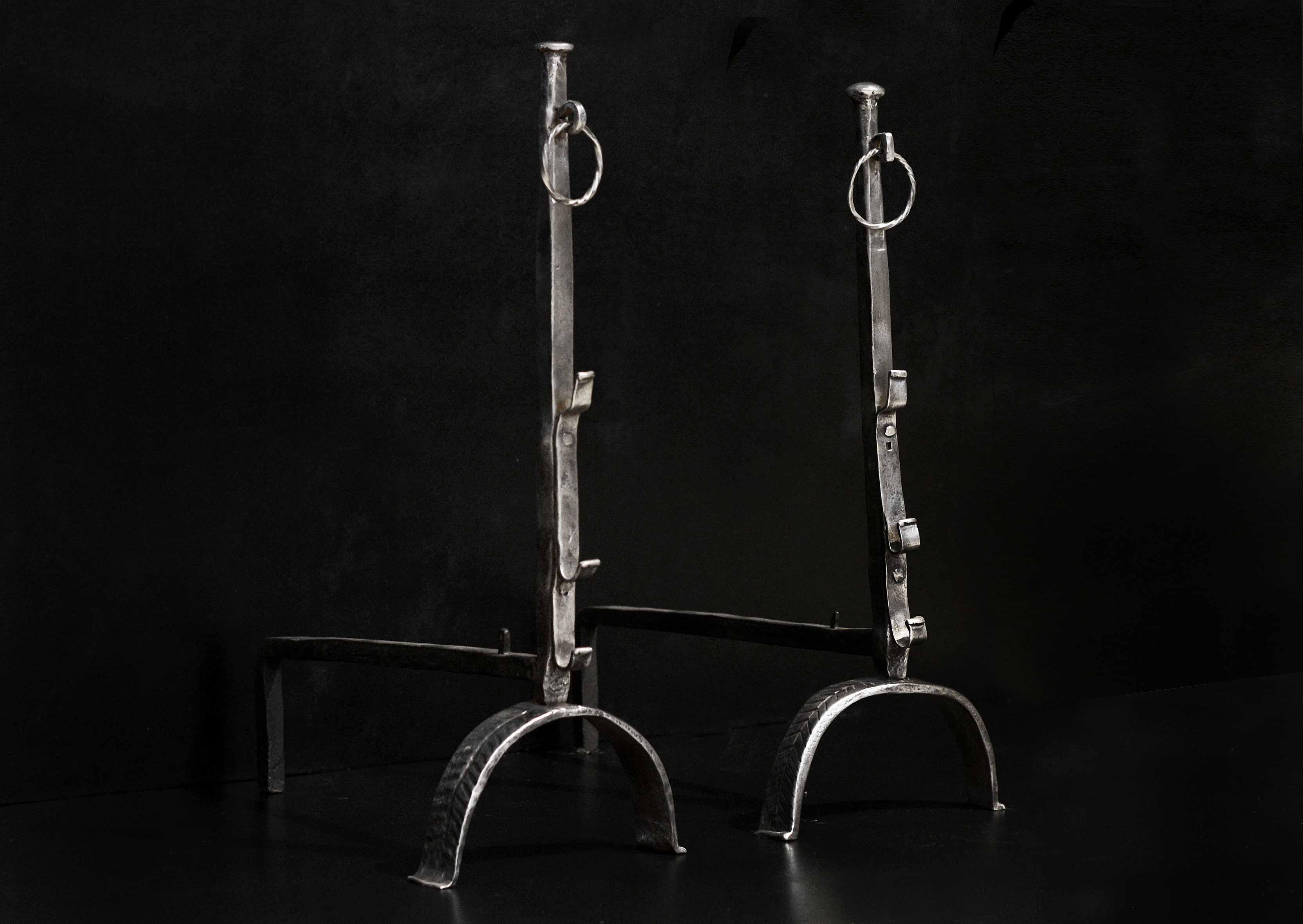 A tall pair of polished wrought iron antique firedogs with hooks to shaft and barley twist ring. French, probably 18th century.

Measures: Height: 825 mm 32 ½