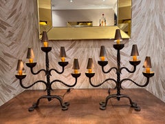 A large pair of wrought iron candelabra table lamps with copper shades