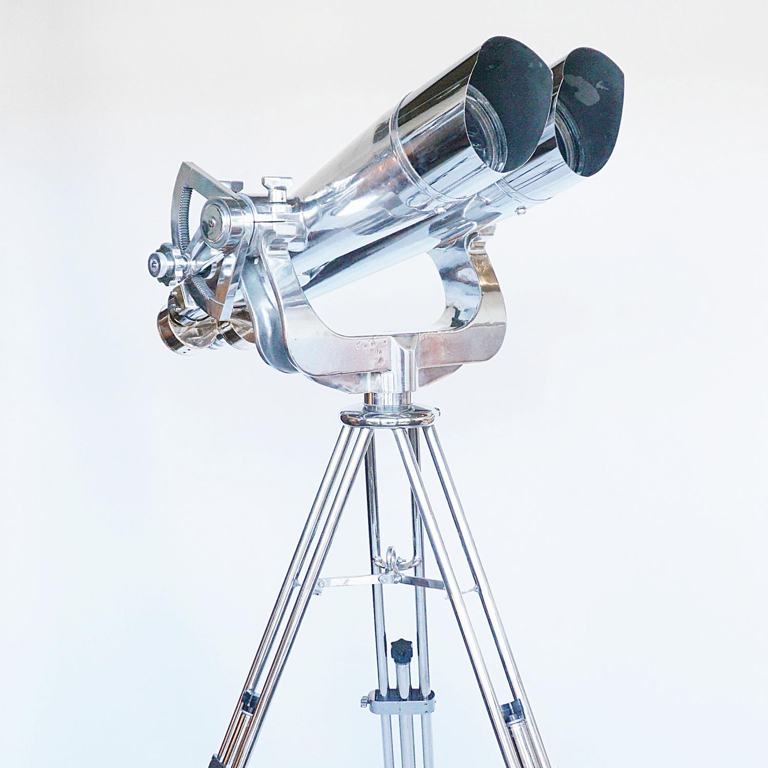 A large pari of chromed metal and brass Nikon 25x150 WWII Naval Binoculars. Set on an original Zeiss 1960's military, re-polished metal stand. 

25x magnification with 150mm objective lenses. Paint stripped and metal polished. Optics fully