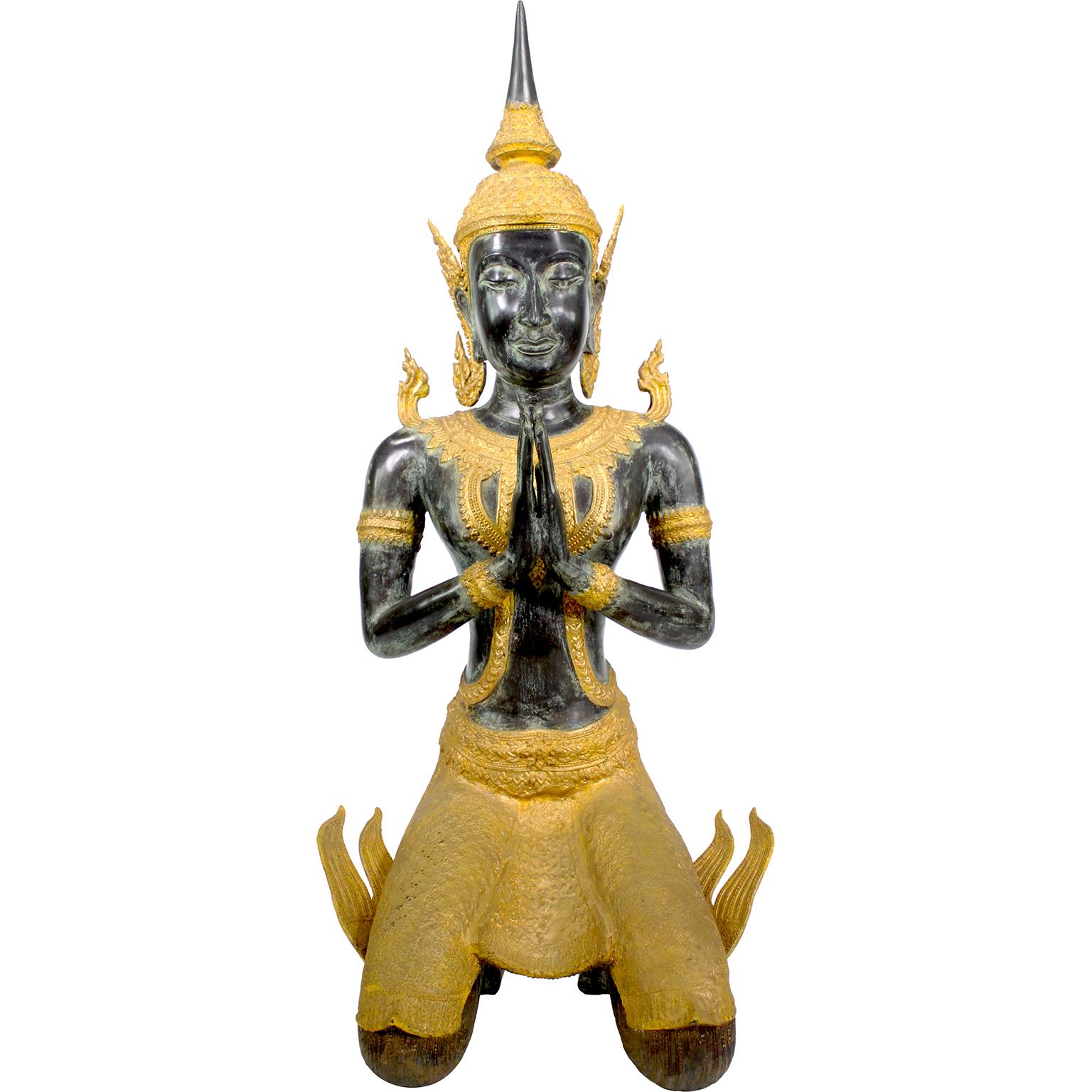 A Large Patinated Bronze and Parcel-Gilt-Bronze Decorative Figure of a Thai Thepphanom Kneeling Angel Buddha. The impressive sculpture of a kneeling angel Buddha, kneeling on both knees with her hands at the wai position, finished in a green/grey