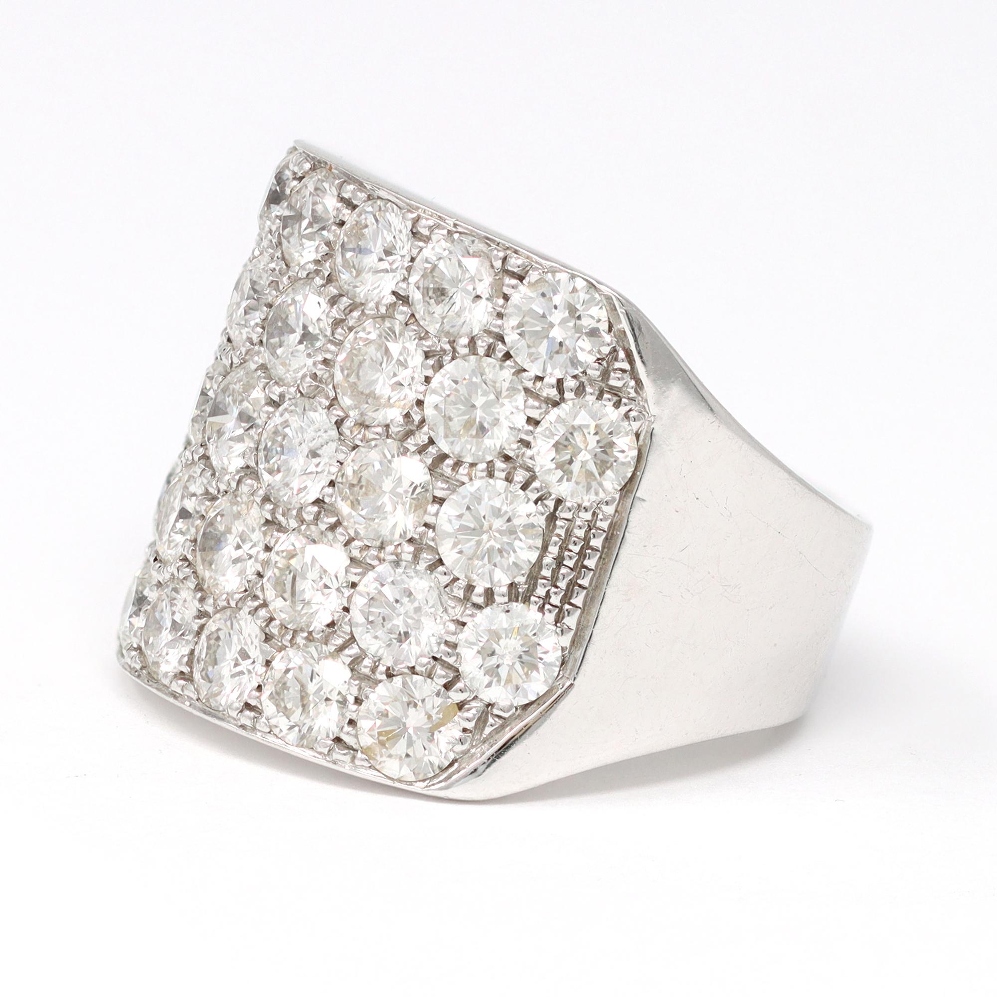 A modern cocktail ring originated in Italy featuring 32 round diamonds of about 30 points each, in pavé setting. The large band ring is set in 14 karat white gold and sits comfortably on the finger. The estimated weight of the diamonds is 8.70