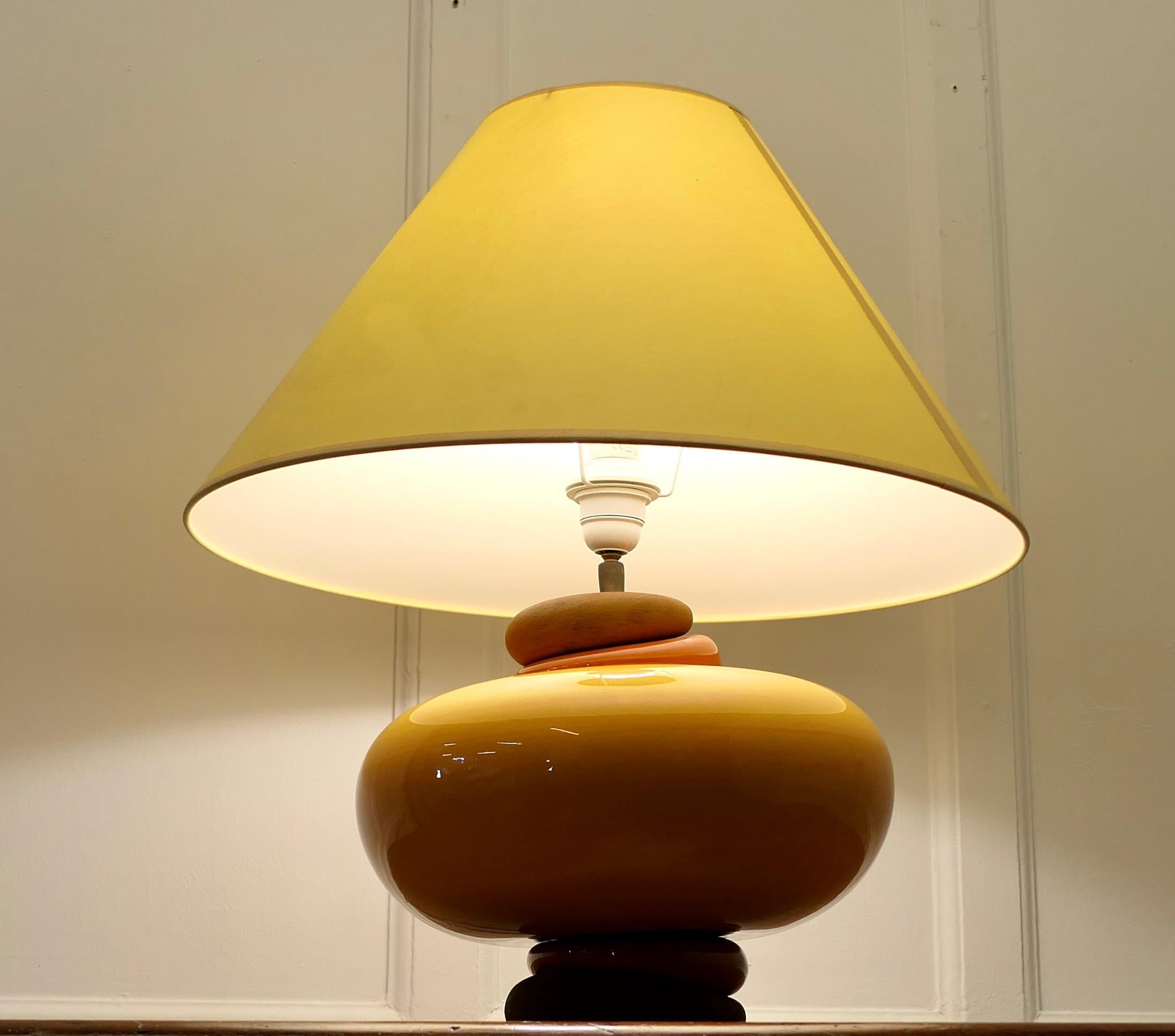 A Large Pebble and Rich Yellow Glass Sideboard Lamp

A Large French piece with layers of Glass and Pebble, the lamp is in bright Summer Colours and has a yellow Coolie Lampshade
All working and a great looker
The lamp is 22” tall, and 13” in