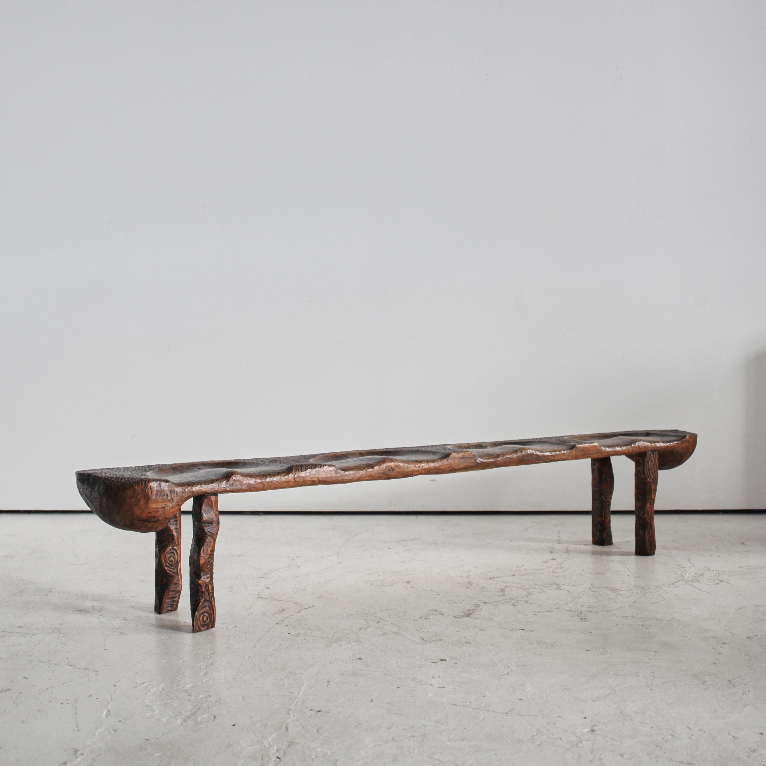 A totally unique profusely carved gouged pine bench from the Polish Sudetes mountains.

Artist made in the brutalist style with references to ancient Polish folklore.
