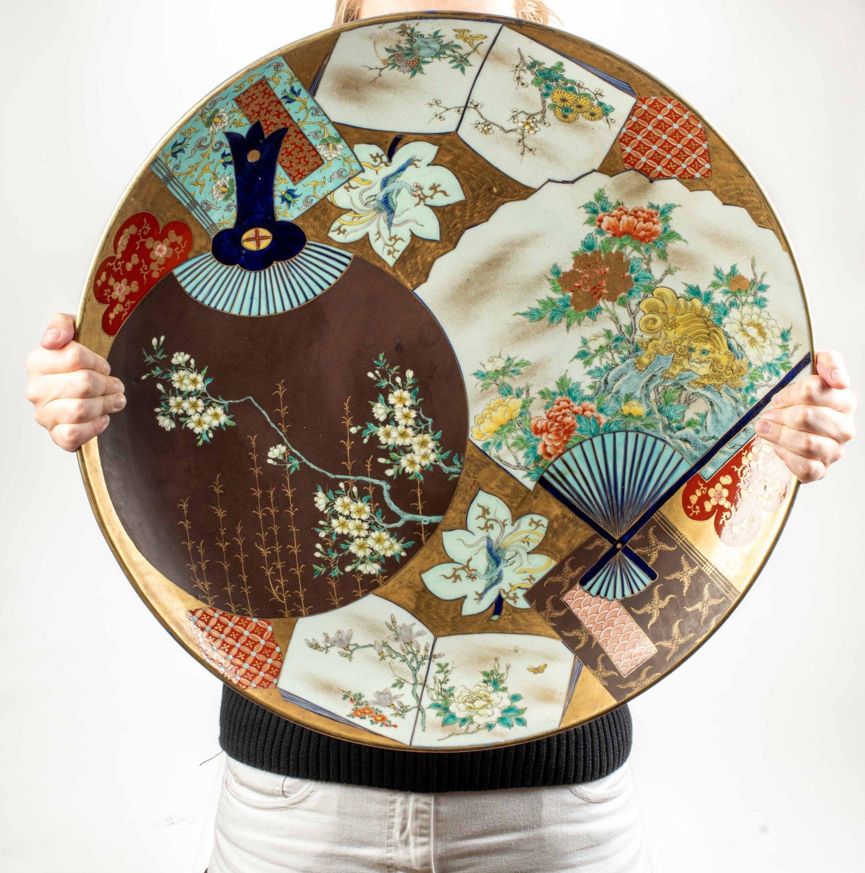 Japonisme A large porcelain plate finely decorated in polychrome with two fans