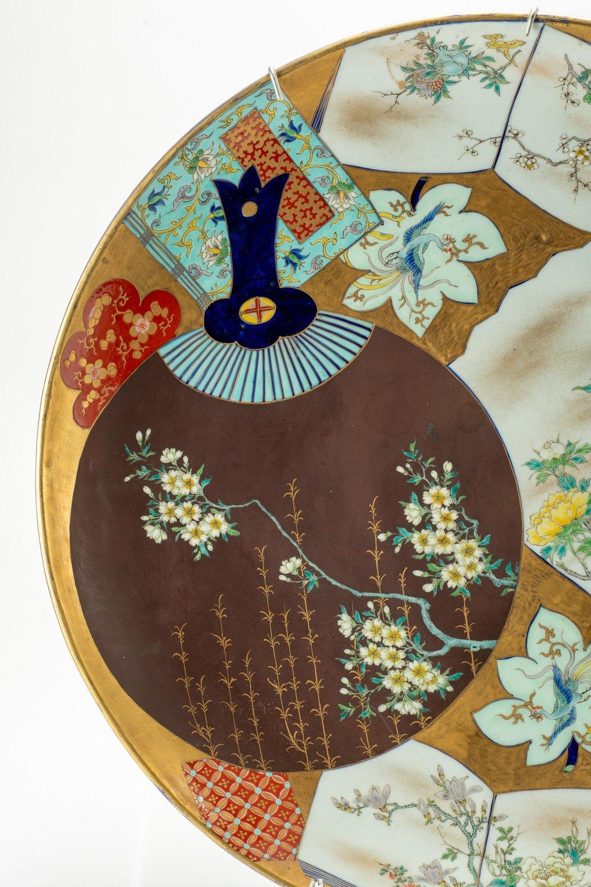 Japanese A large porcelain plate finely decorated in polychrome with two fans