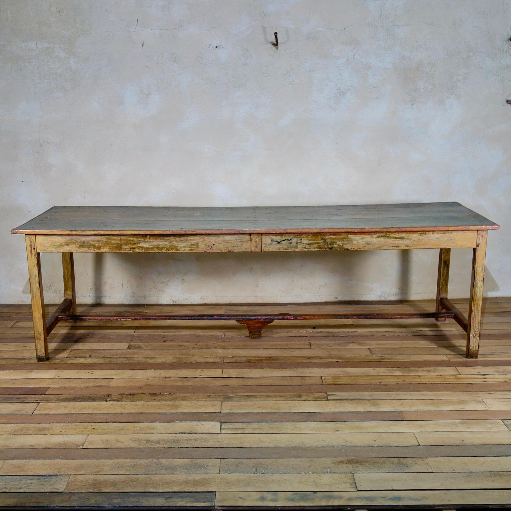 An exceptional large 19th-century French refectory table.  Displaying its original cream wash paint to the base, with subtle accents of green and pink paint throughout - originating from years of use in a French school, a lovely unique addition to