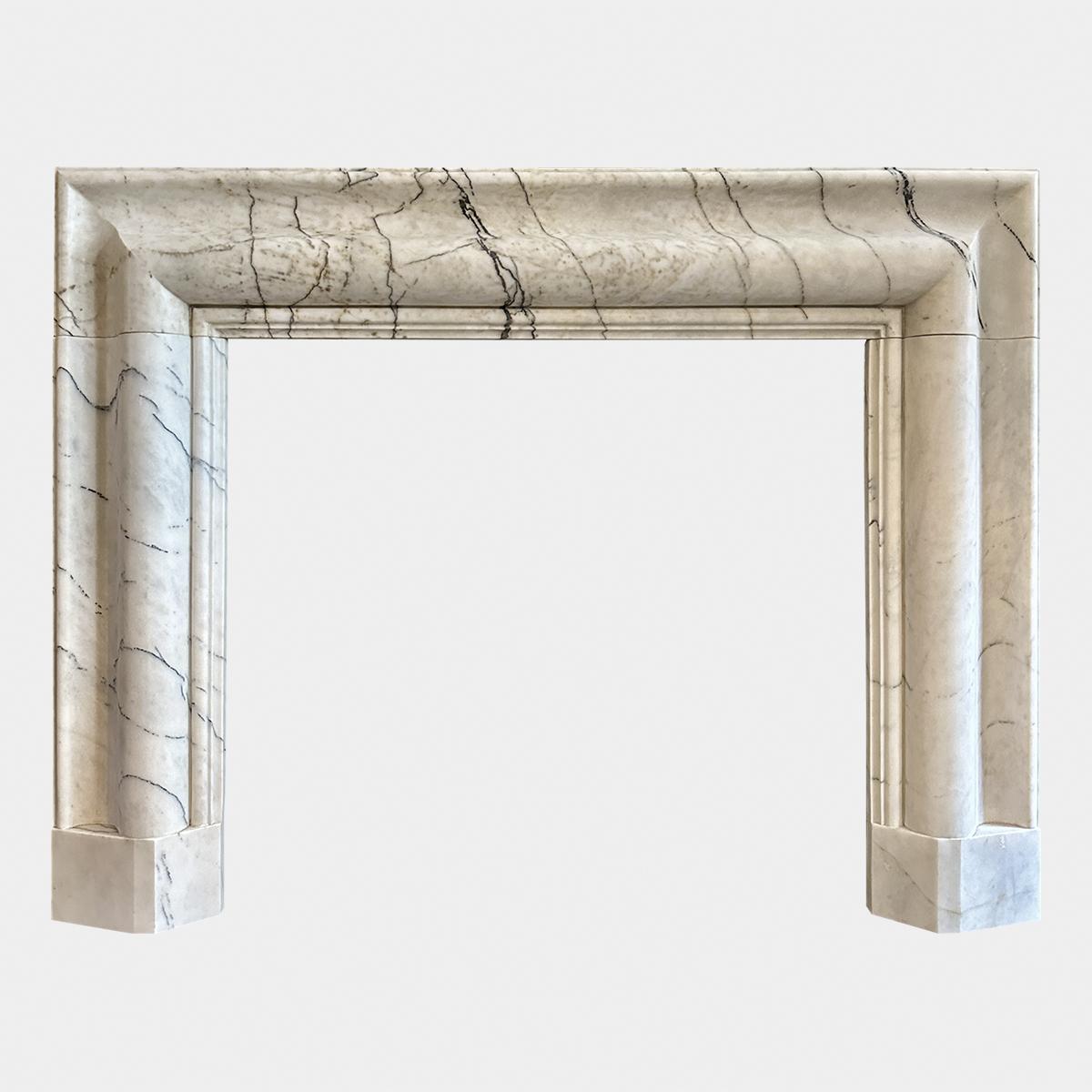 A large substantial Bolection fireplace in a Variant of Carrara marble known as Calacatta Vagli. Generous mouldings giving a wide frame and header with carved inner slip. Stood on shaped foot blocks. Good quality surround made in superior Italian