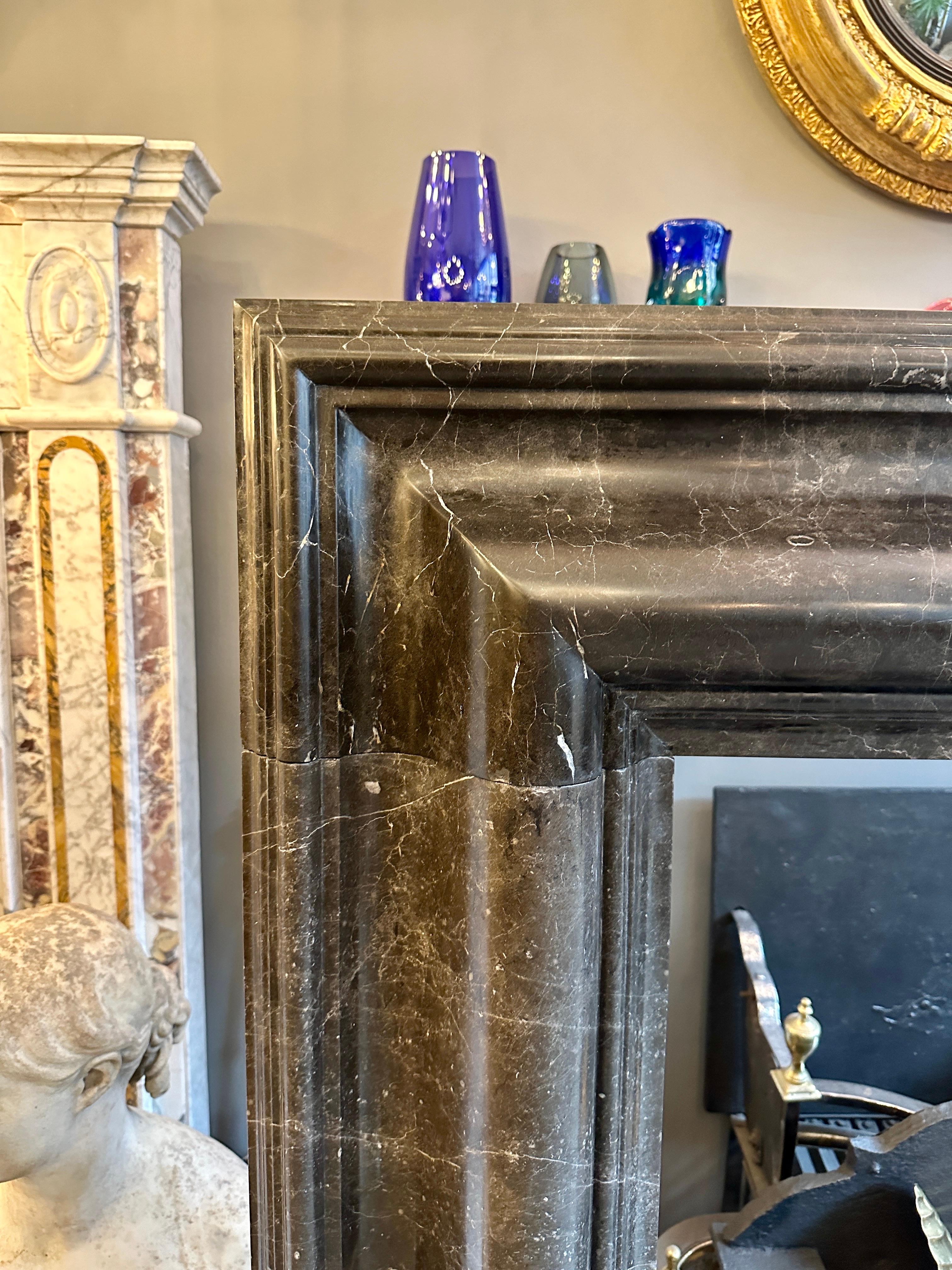 Georgian A Large Reclaimed Black Marble Bolection Fireplace Mantel For Sale