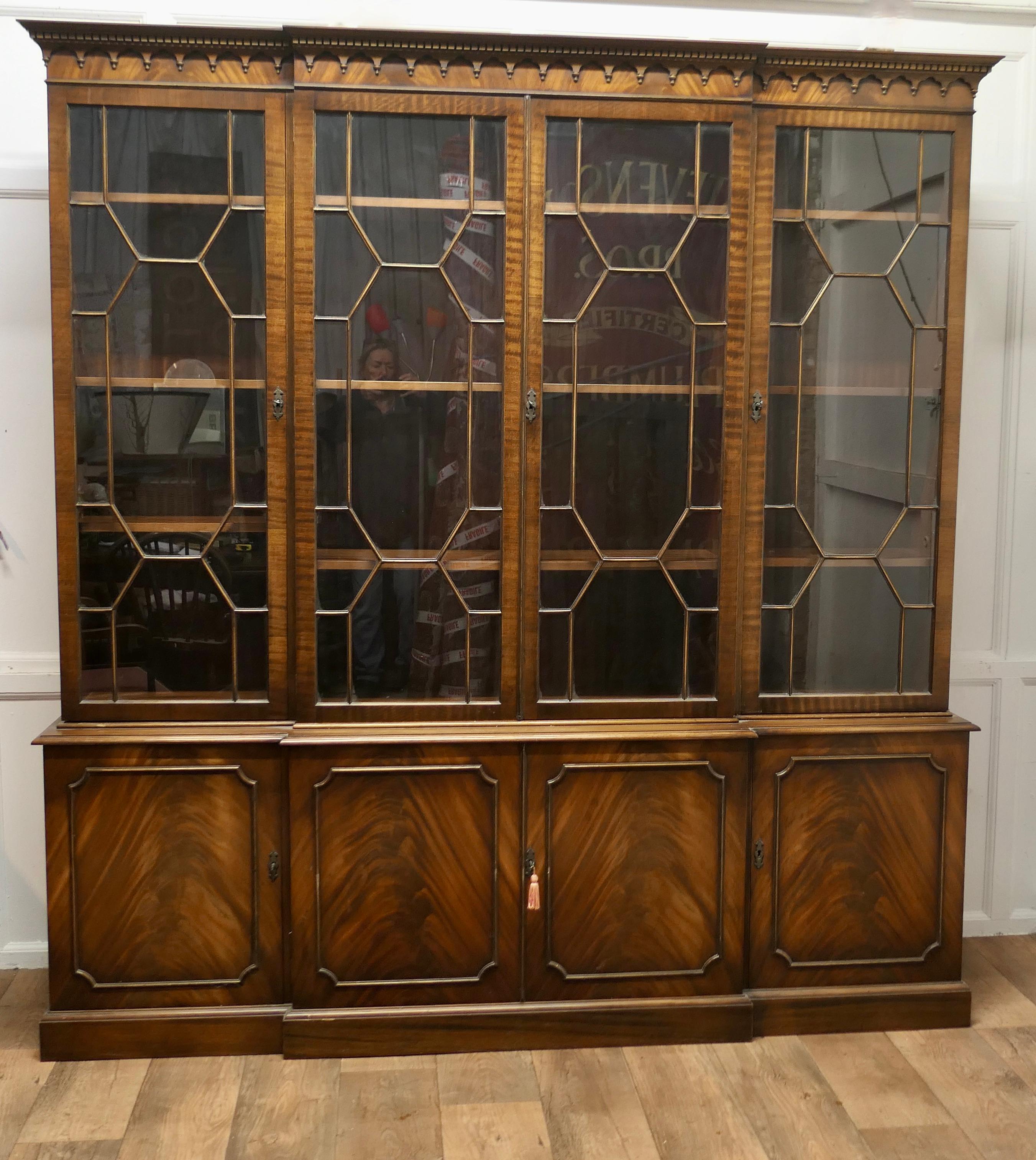 A Large Reprodux Break Front Bookcase  by Bevan Funnell

An excellent looking piece with a decorative cornice, it has four glazed doors to the top and 4 panelled doors below

The top Section of the bookcase has 4 Astral Glazed Doors, enclosing