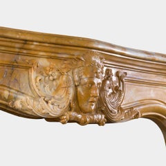 A Large Rococo Carved Siena Marble Fireplace Mantel
