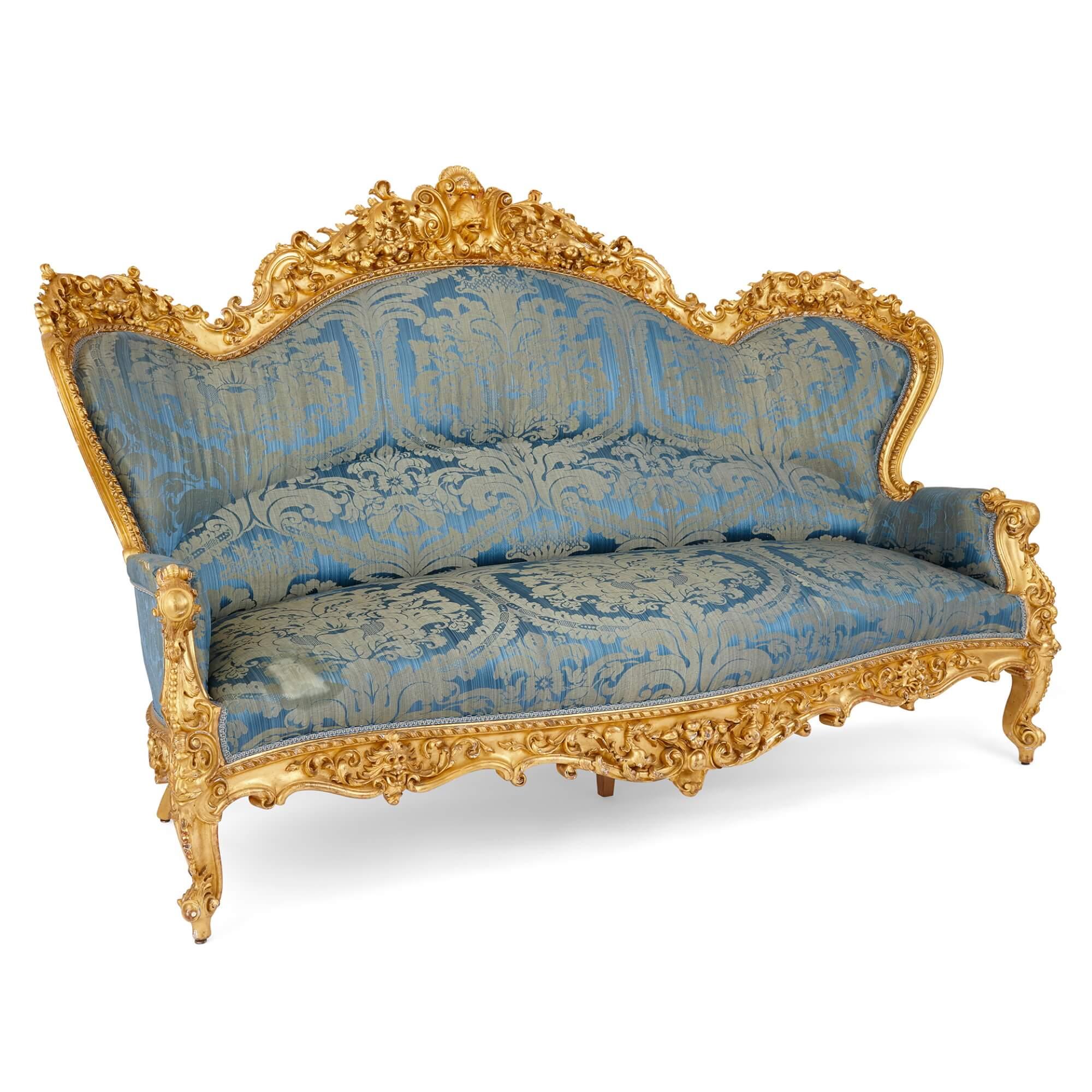 A large Rococo revival carved giltwood sofa
French, Late 19th Century
Height 135cm, width 196cm, depth 90cm

This excellent antique piece is a large, French, late nineteenth century Rococo revival carved giltwood sofa. The sofa's frames are