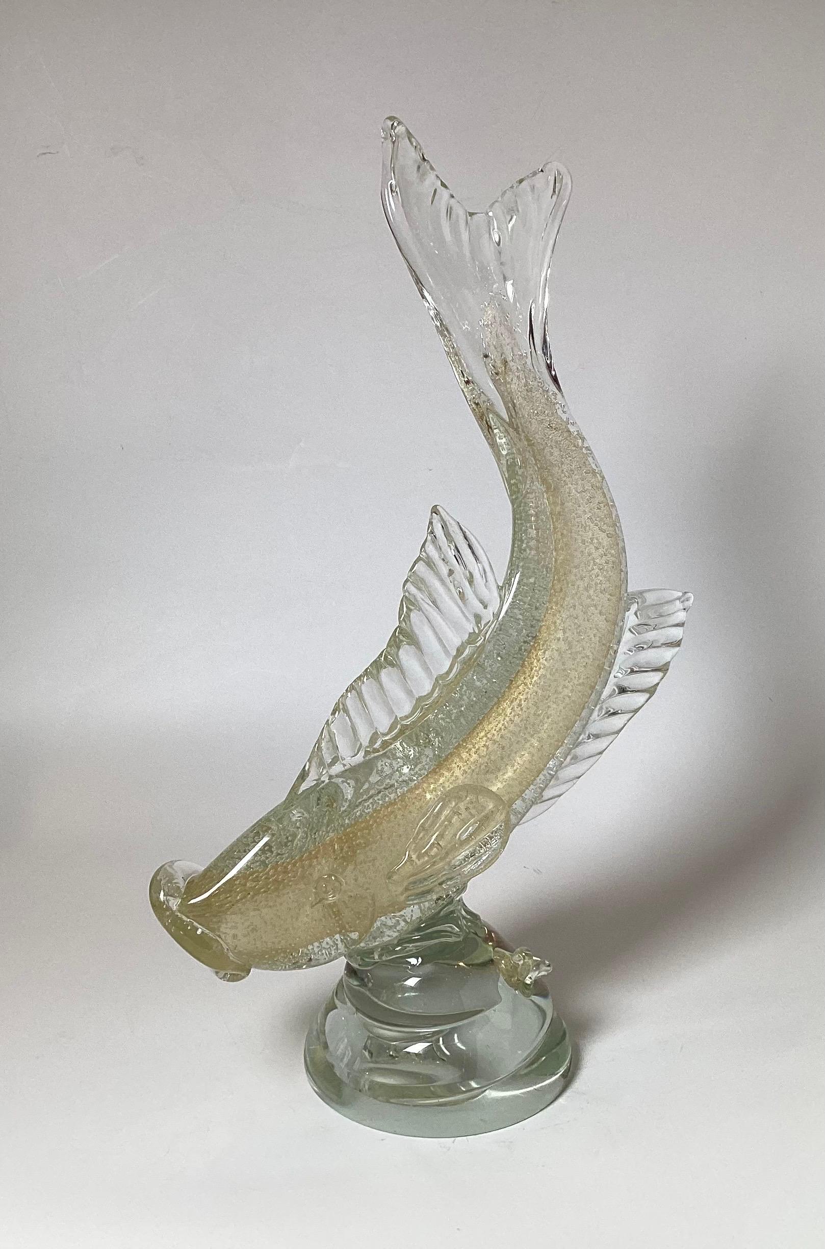 A large and impressive Murano glass fish with bullicante controlled bubbles attributed to Salviatt and Co.  The elegant form with the fish tail curved upward with a sturdy round glass attached base.  21.5 inches tall. 
