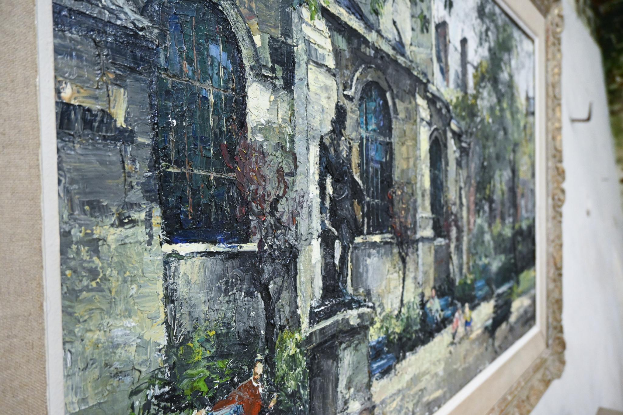 A large scale signed oil on canvas painting by the Latvian born painter Constantin Kluge - known for his French landscapes and romantic scenes of Paris. A striking painting, depicting figures and children playing in a park by the grounds of a church