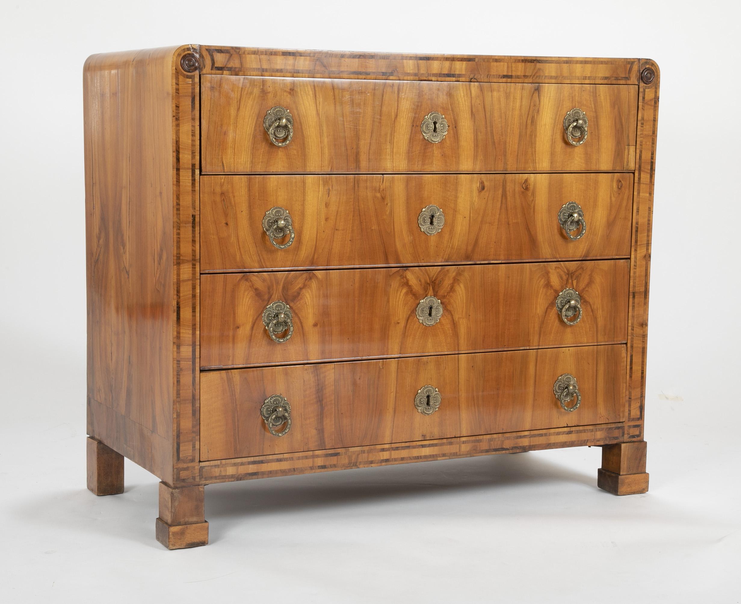 A large walnut chest with top drawer functioning as a secretary. Sharing many similarities with Biedermeier furniture while being firmly in the Italian framework in terms of treatment of veneers, secondary woods and mounts.