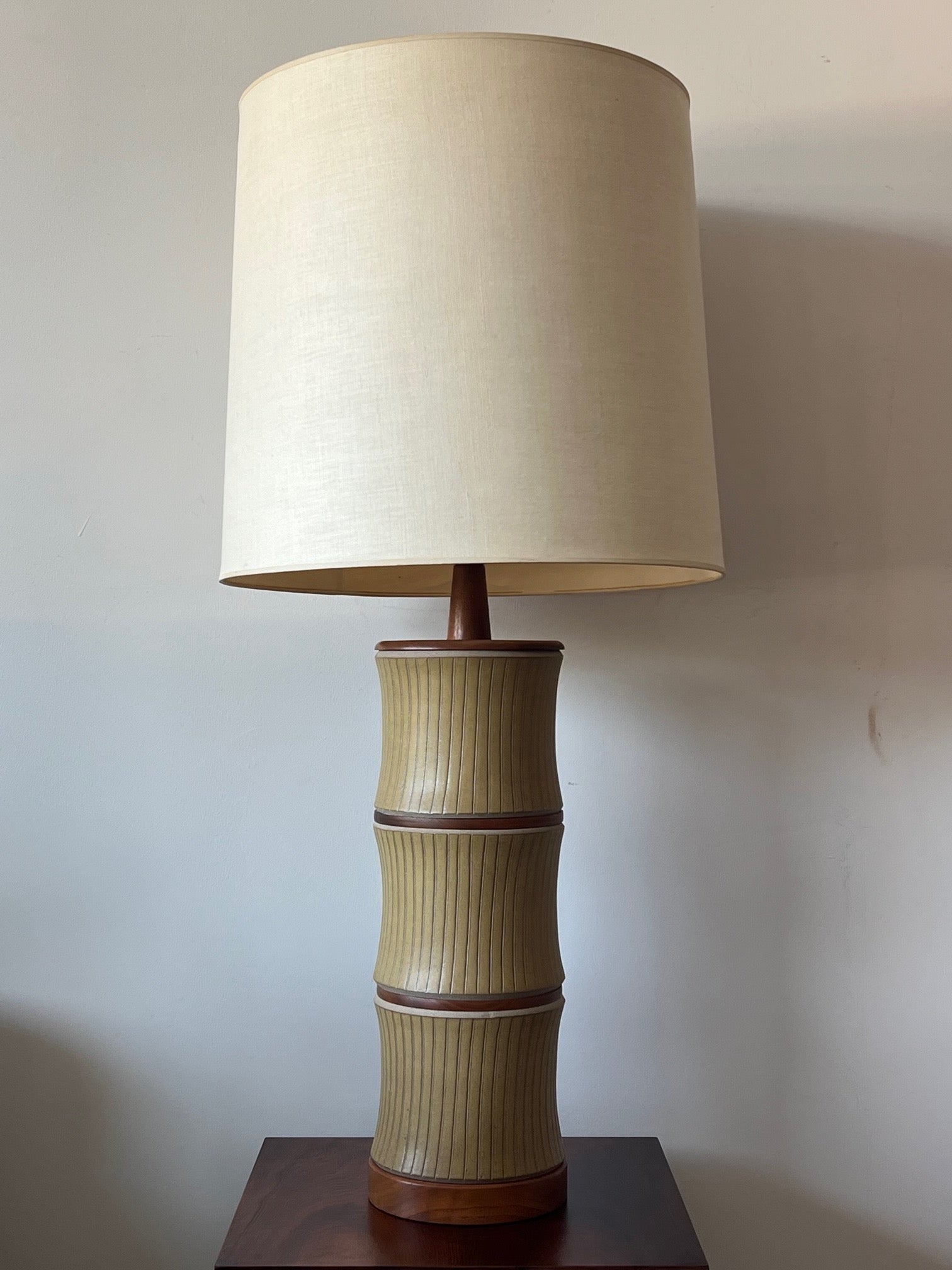 An outstanding stacked stoneware and walnut lamp by Gordon and Jane Martz ca' 1960's. Model 221 with yellow satin glaze and incise decoration. Original shade, original finial, purchased from original owner.